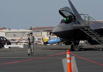 Airman 1st Class Collin Johnson, 9th Security Forces Squadron secures the flight-line around a United States Air Force F-22 Raptor during the California Capital Airshow in Sacramento, Calif., Sept. 6, 2014.  The Raptors primary mission is air dominance. (U.S. Air Force photo by Staff Sgt. Robert M. Trujillo/Released)