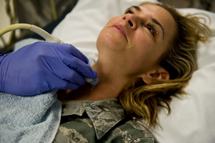Staff Sgt. Tristan Traore, 99th Medical Surgical Operations Squadron ultrasound technologist, performs an ultrasound demonstration on Staff Sgt. Jessica Corley, 99th MSGS ultrasound technologist, at Mike O’ Callaghan Federal Medical Center on Nellis Air Force Base, Nev., Aug. 26, 2014. The diagnostic imaging department performs approximately 700 ultrasounds per month for Department of Defense and Department of Veterans Affairs medical beneficiaries. (U.S. Air Force photo by Airman 1st Class Mikaley Towle)
