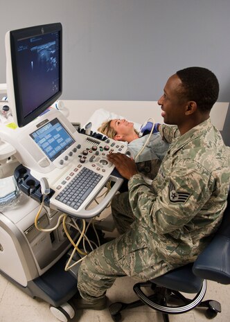 Staff Sgt. Tristan Traore, 99th Medical Surgical Operations Squadron ultrasound technologist, demonstrates an ultrasound on Staff Sgt. Jessica Corley, 99th MSGS ultrasound technologist at the Mike O’Callaghan Federal Medical Center, Nellis Air Force Base, Nev., Aug. 26, 2014. The diagnostic imaging department performs approximately 4,000 exams per month using X-ray, MRI, ultrasound, mammography, nuclear medicine, and CT-scan machines.  (U.S. Air Force photo by Airman 1st Class Thomas Spangler)