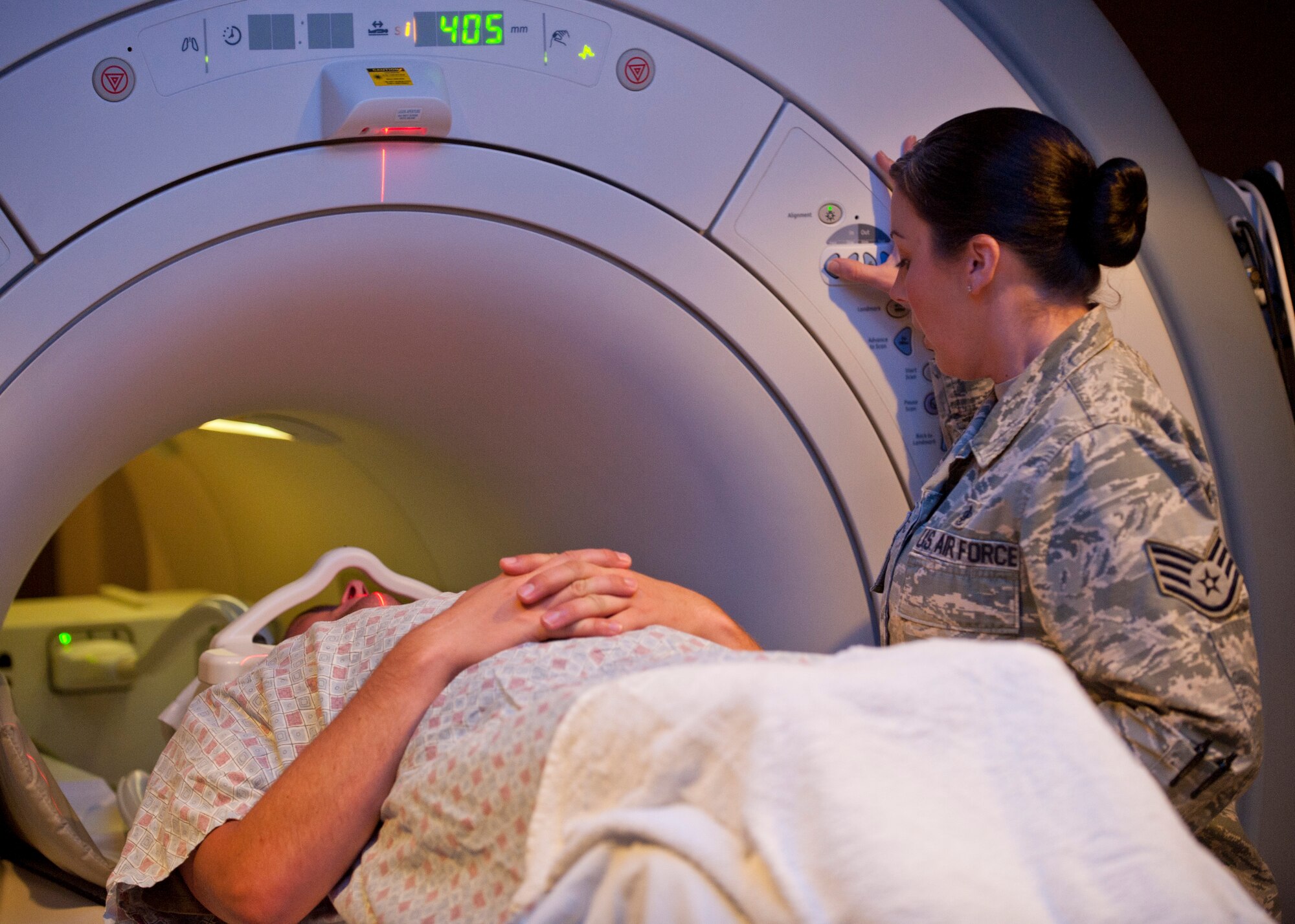 Staff Sgt. Jana Brightman, 99th Medical Support Group MRI technologist, prepares a patient for an MRI at the Mike O’Callaghan Federal Medical Center, Nellis AFB, Nev., Aug. 26, 2014.  According to the U.S. National Library of Medicine National Institutes of Health website, an MRI scan is an imaging test that uses powerful magnets and radio waves to create pictures of the body. (U.S. Air Force photo by Airman 1st Class Thomas Spangler)