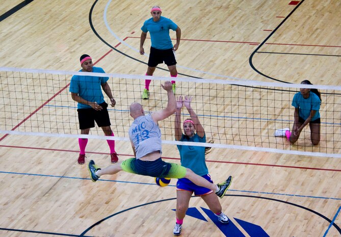 Members of the 99th Medical Group (Blue) and the 823rd Maintanence Squadron play a neck-and-neck game during the intramural volleyball playoffs at the Warrior Fitness Center on Nellis Air Force Base, Nev., Sept. 9, 2014. The 99th MDG won the game 25 to 23, breaking the 823rd MXS’ undefeated streak and  earning a spot in the next round of the playoffs. (U.S. Air Force photo by Airman 1st Class Rachel Loftis )