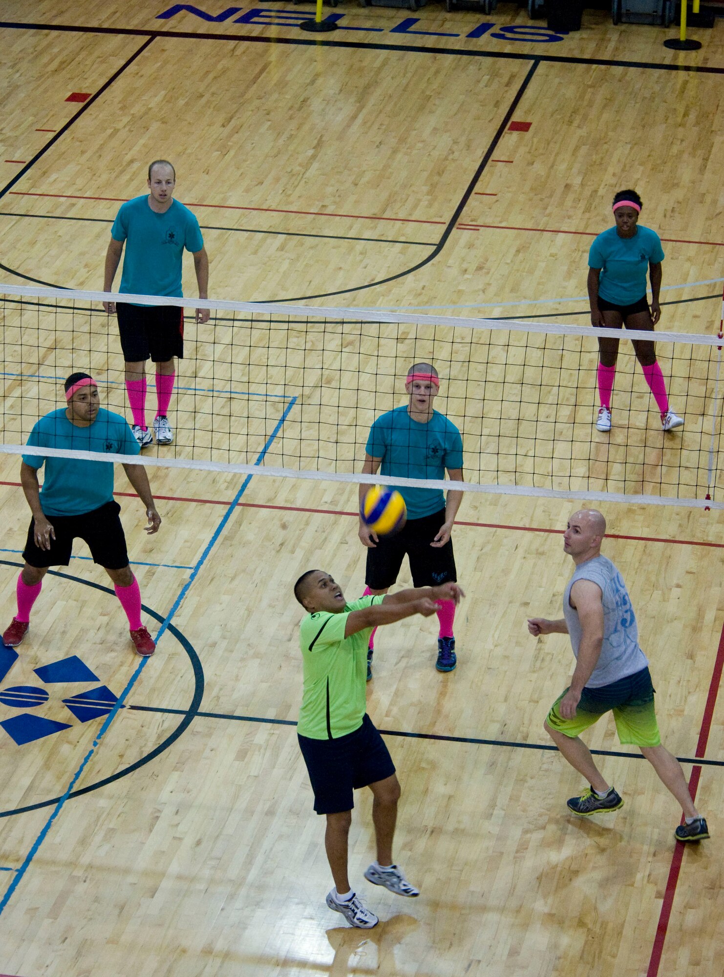 Members of the 99th Medical Group (Blue) and 823rd Maintanence Squadron square off during the intramural volleyball playoffs at the Warrior Fitness Center on Nellis Air Force Base, Nev., Sept. 9, 2014. The 823rd MXS was undefeated all season until the 99th MDG pulled together and took the win, 25 to 23. (U.S. Air Force photo by Airman 1st Class Rachel Loftis )