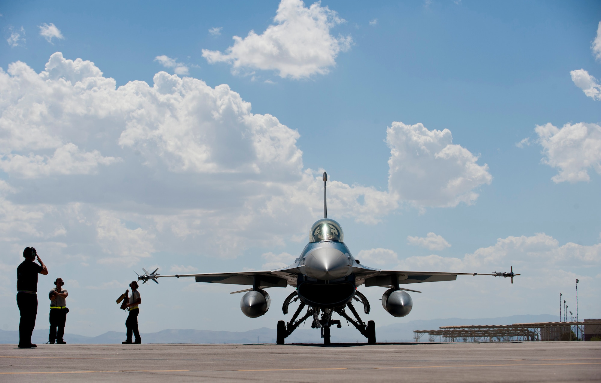 Tech. Sgt. Bradley Schuster, 57th Aircraft Maintenance Squadron Viper Aircraft Maintenance Unit crew chief, salutes a 64th Aggressor Squadron pilot before the aircraft taxis to the runway at Nellis Air Force Base, Nev., Sept. 5, 2014. The Viper AMU is responsible for maintaining, launching and recovering the F-16 Fighting Falcons. (U.S. Air Force photo by Airman 1st Class Thomas Spangler)