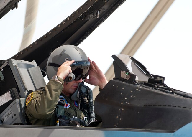 Royal Air Force Sqn. Ldr. James Jody McMeeking, an exchange pilot assigned to the 64th Aggressor Squadron, prepares for flight in an F-16 Fighting Falcon at Nellis Air Force Base, Nev., Sept. 5, 2014. McMeeking is part of the Military Personnel Exchange Program between the RAF and the U.S. Air Force. The program is designed to build relationships necessary to ensure personnel from the two countries are able to work together effectively and efficiently in future operations. McMeeking will be assigned to the 64th AGS for the next three years. (U.S. Air Force photo by Airman 1st Class Thomas Spangler)