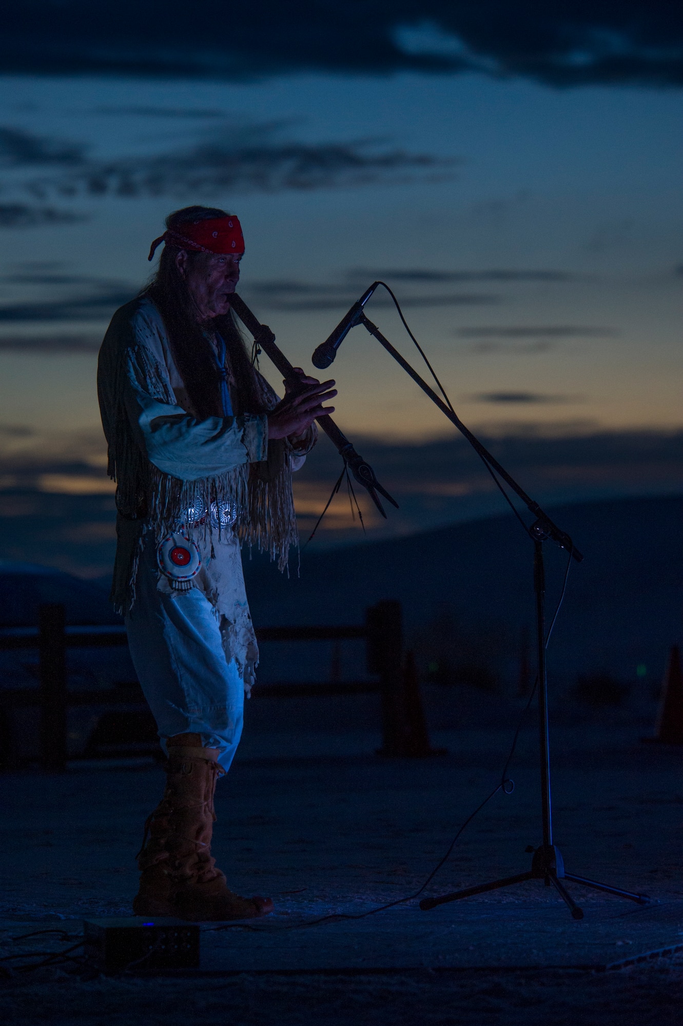 Ernie Dogwolf Lovato, a musician, story teller and native New Mexican, plays the flute during his Full Moon Night performance at White Sands National Monument, Sept. 8. White Sands National Monument hosts a monthly full moon night event where various featured guests and activities are planned for the guests to enjoy under a rising full moon. (U.S. Air Force photo by Airman 1st Class Aaron Montoya / Released)
