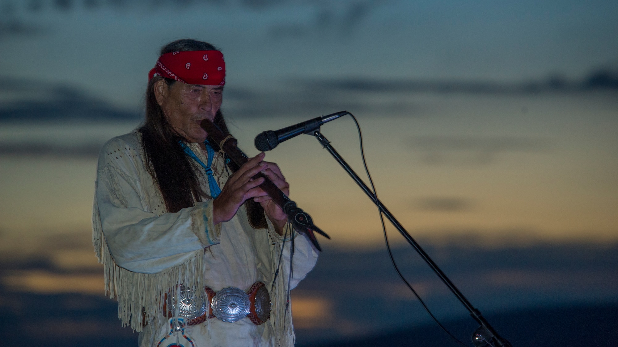 Ernie Dogwolf Lovato, a musician, story teller and native New Mexican, plays the flute during his Full Moon Night performance at White Sands National Monument, Sept. 8. White Sands National Monument hosts a monthly full moon night event where various featured guests and activities are planned for the guests to enjoy under a rising full moon. (U.S. Air Force photo by Airman 1st Class Aaron Montoya / Released)