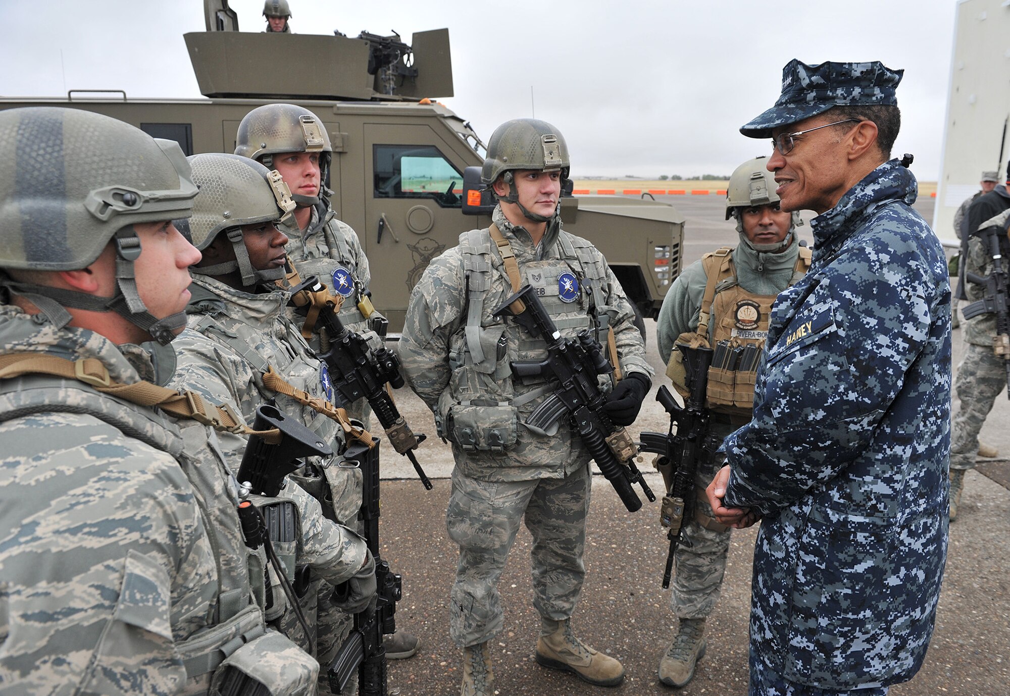 Adm. Cecil D. Haney, U.S. Strategic Command commander, right, talks with 341st Security Forces Group members Sept. 9 during a missile convoy display at Malmstrom Air Force Base, Mont. Shown with the admiral are Airman 1st Class Randi Law, Staff Sgt. Sydney Farries, Senior Airman Justin Parker, and Staff Sgt. Joseph Geib, all 741st Missile Security Forces Squadron members, and Staff Sgt. Hector Rivera-Bonilla, 341st SFG tactical response force member. USSTRATCOM is one of nine DoD unified combatant commands and is charged with strategic deterrence, space operations, cyberspace operations, joint electronic warfare, global strike, missile defense, intelligence, surveillance and reconnaissance, combating weapons of mass destruction, and analysis and targeting. (U.S. Air Force photo/John Turner)