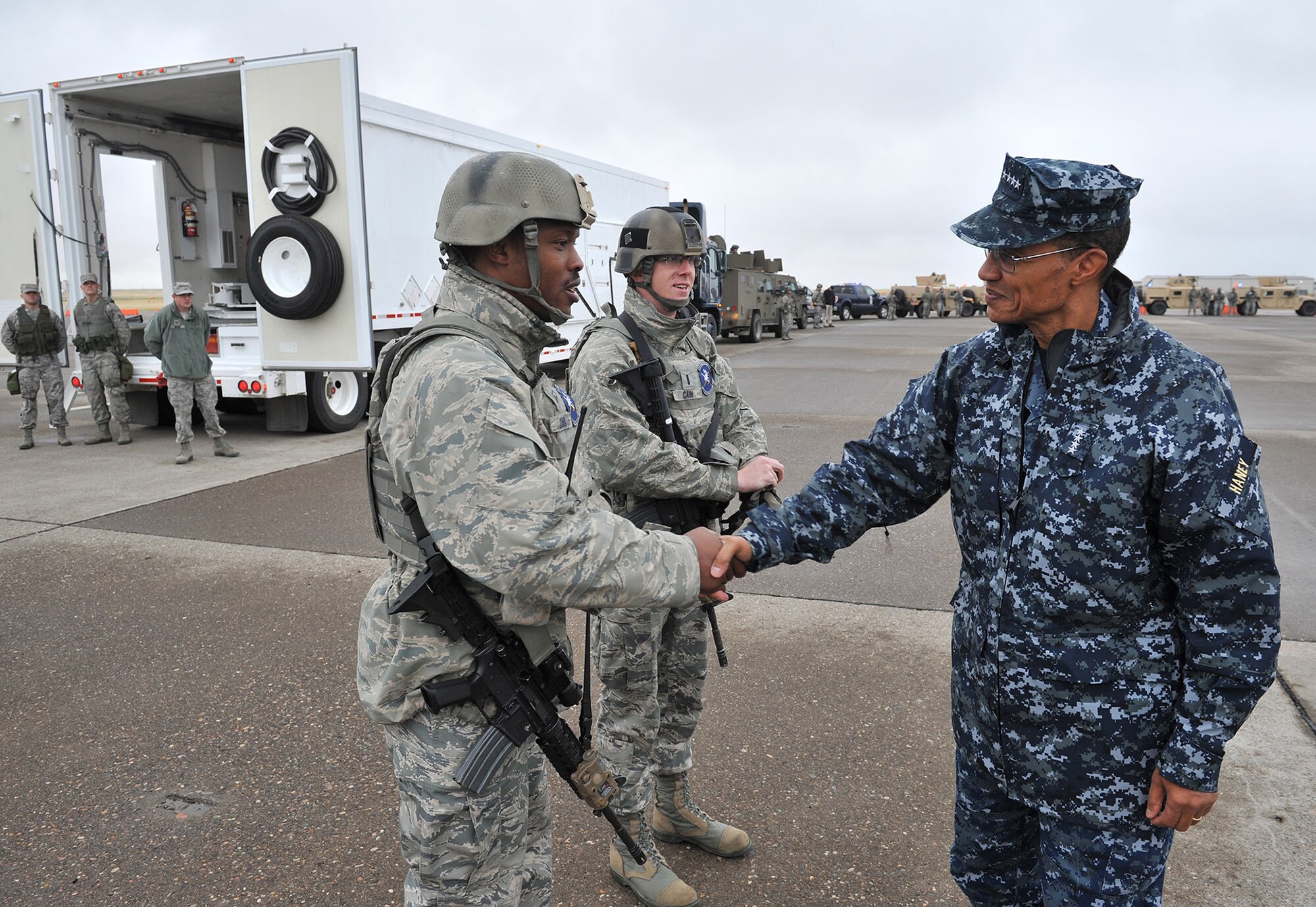Master Sgt. Christopher Clark and 1st Lt. Matthew Cain, 741st Missile Security Forces Squadron convoy response force members, shake hands with Adm. Cecil D. Haney, U.S. Strategic Command commander Sept. 9 during a missile convoy display at Malmstrom Air Force Base, Mont. USSTRATCOM is one of nine DoD unified combatant commands and is charged with strategic deterrence, space operations, cyberspace operations, joint electronic warfare, global strike, missile defense, intelligence, surveillance and reconnaissance, combating weapons of mass destruction, and analysis and targeting. (U.S. Air Force photo/John Turner)