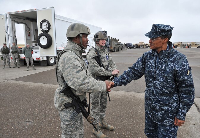 Master Sgt. Christopher Clark and 1st Lt. Matthew Cain, 741st Missile Security Forces Squadron convoy response force members, shake hands with Adm. Cecil D. Haney, U.S. Strategic Command commander Sept. 9 during a missile convoy display at Malmstrom Air Force Base, Mont. USSTRATCOM is one of nine DoD unified combatant commands and is charged with strategic deterrence, space operations, cyberspace operations, joint electronic warfare, global strike, missile defense, intelligence, surveillance and reconnaissance, combating weapons of mass destruction, and analysis and targeting. (U.S. Air Force photo/John Turner)