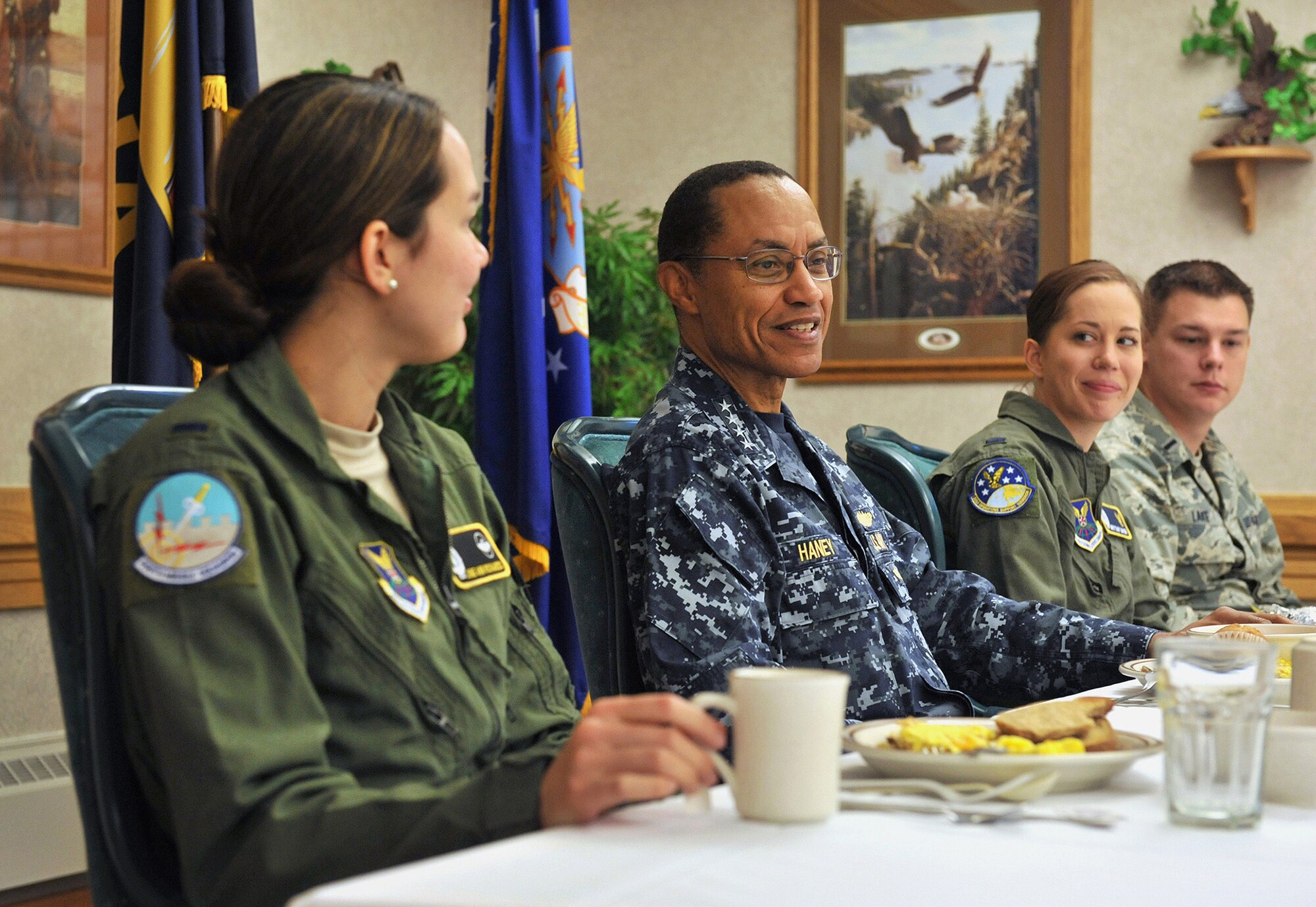 Adm. Cecil D. Haney, U.S. Strategic Command commander, center, talks with ICBM missile combat crew officers assigned to the 341st Missile Wing Sept. 9 during a breakfast at Malmstrom Air Force Base, Mont. Pictured with the admiral are: 1st Lt. June Richards, 490th Missile Squadron, left; 1st Lt. Brittany Baver, 341st Operations Support Squadron; and 1st Lt. Andrew Lake, 10th MS. USSTRATCOM is one of nine DoD unified combatant commands and is charged with strategic deterrence, space operations, cyberspace operations, joint electronic warfare, global strike, missile defense, intelligence, surveillance and reconnaissance, combating weapons of mass destruction, and analysis and targeting. (U.S. Air Force photo/John Turner)