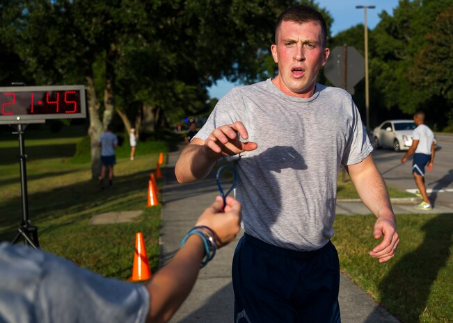 Volunteers hand out Run For a Life Bracelets to runners as they finish the Run For a Life 5K, Sept. 5, 2014, at Joint Base Charleston S.C. The Run For a Life 5K was held as part of the base’s monthly Fitness Challenge and helped to promote resiliency and raise awareness about suicide and prevention. Prior to the start of the run, Gail Meminger Rush, guest speaker, talked to the group and shared a personal story about the loss of a loved one. Rush lost her daughter to suicide in Jan. 3, 2012. As part of Suicide Awareness Month, members of the Mental Health Clinic will host information booths at the Air Base Exchange, Sept. 12, 17 and 26 from 10:30 a.m. until 1:30 p.m.; the Gaylord Dining Facility, Sept. 10, 15 and 19 from 10:30 a.m. to 1 p.m.; the Air Base Bowling Alley, Sept. 24 and 29 from 10:30 a.m. to 1:30 p.m., and the Air Base Fitness Center, Sept. 5, 8 and 22 from 2 p.m. to 5 p.m. They will also be making personal visits to some workstations around the installation.  (U.S. Air Force photo/Staff Sgt. William O'Brien)
