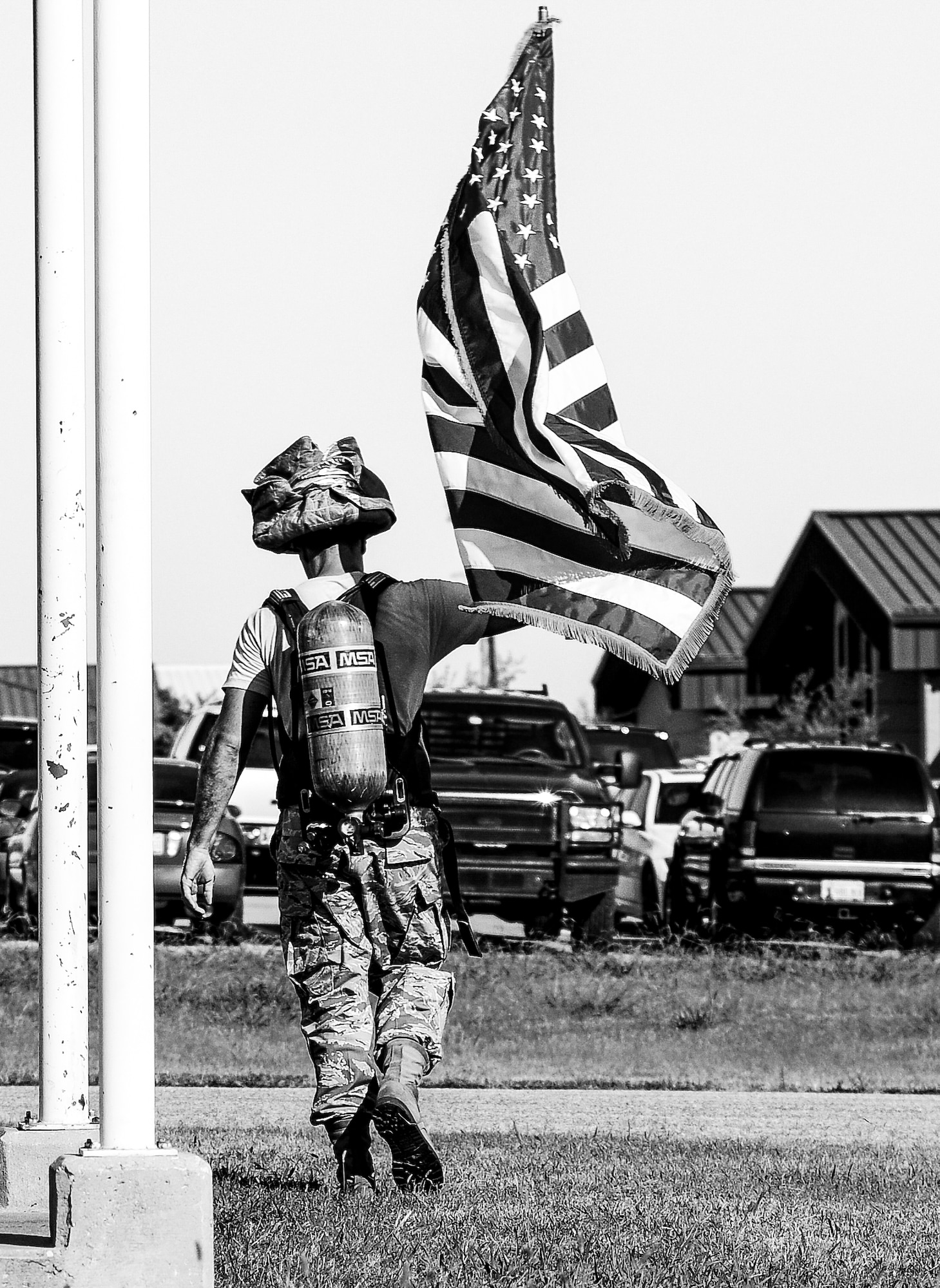 Master Sgt. Carl Hojnacki carries the U.S. flag as he finishes the 5th annual fire climb Sept. 7 at the fire training tower here.  Reservists from the CES and 507th took turns carrying the flag up and down the equivalent of 110 stories to commemorate the 343 firefighters, emergency medical technicians and paramedics who lost their lives during the 9/11 attacks on the World Trade Centers.  (U.S. Air Force photo/Senior Airman Mark Hybers)