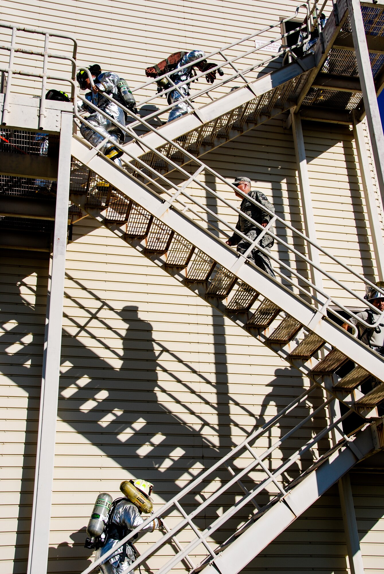 Firefighters and 507th Air Refueling Wing Reservists climb the outside of the fire tower during the 5th annual fire climb Sept. 7 here.  Reservists from the CES and 507th climbed up and down the equivalent of 110 stories to commemorate the 343 firefighters, emergency medical technicians and paramedics who lost their lives during the 9/11 attacks on the World Trade Centers.  (U.S. Air Force photo/Senior Airman Krystin Trosper)