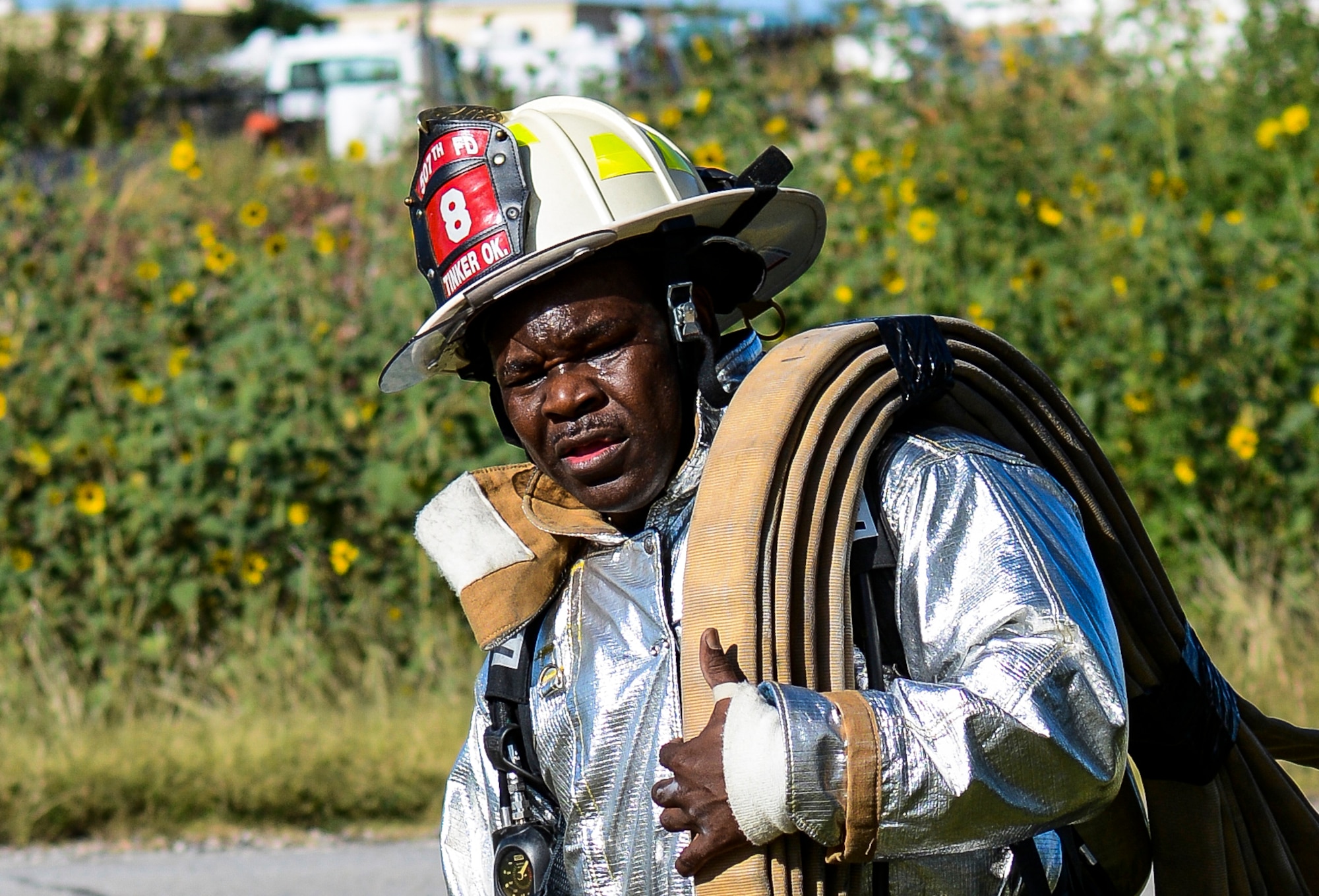 Master Sgt. Adrain Smith, 507th Civil Engineer Squadron assistant chief of operations carries a fire hose in the hot sun during the 5th annual fire climb Sept. 7 at the fire training tower here.  Reservists from the CES and 507th climbed up and down the equivalent of 110 stories to commemorate the 343 firefighters, emergency medical technicians and paramedics who lost their lives during the 9/11 attacks on the World Trade Centers.  (U.S. Air Force photo/Senior Airman Mark Hybers)