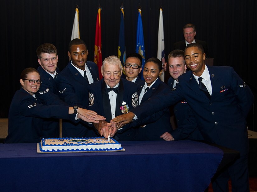 Retired Chief Master Sgt. Robert Gaylor, the fifth Chief Master Sergeant of the Air Force, along with several Airmen who enlisted in 2014, cut the ceremonial cake at this year's Air Force Ball Sept. 6, 2014, at the North Charleston Convention Center in North Charleston, S.C. The cake-cutting ceremony is traditionally performed by the oldest and youngest Airmen in attendance. This year's ball celebrated 67 years of military superiorty through air power. (U.S. Air Force Photo/Tech. Sgt. Rasheen Douglas)