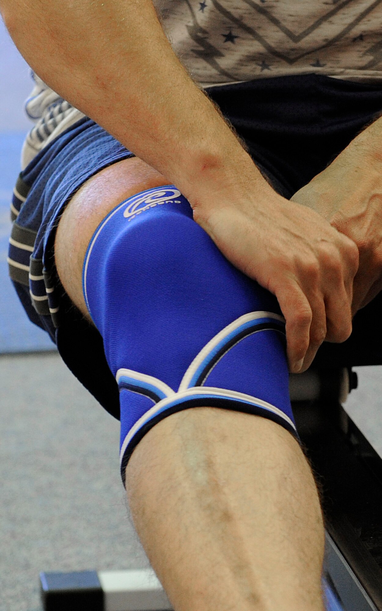 U.S. AIR FORCE ACADEMY, Colo. – Master Sgt. Benjamin “Paul” Horton. 21st Civil Engineer Squadron explosive ordnance disposal program manager, adjusts his knee brace after working out on the rowing machine at the Academy Fitness Center Sept. 3. Horton is training for the first-ever Invictus Games, which will take place in London Sept. 10-14. The Games will help combat warriors prove they still have a purpose and cannot be defeated just from being wounded in combat. (U.S. Air Force photo/Airman 1st Class Rose Gudex)