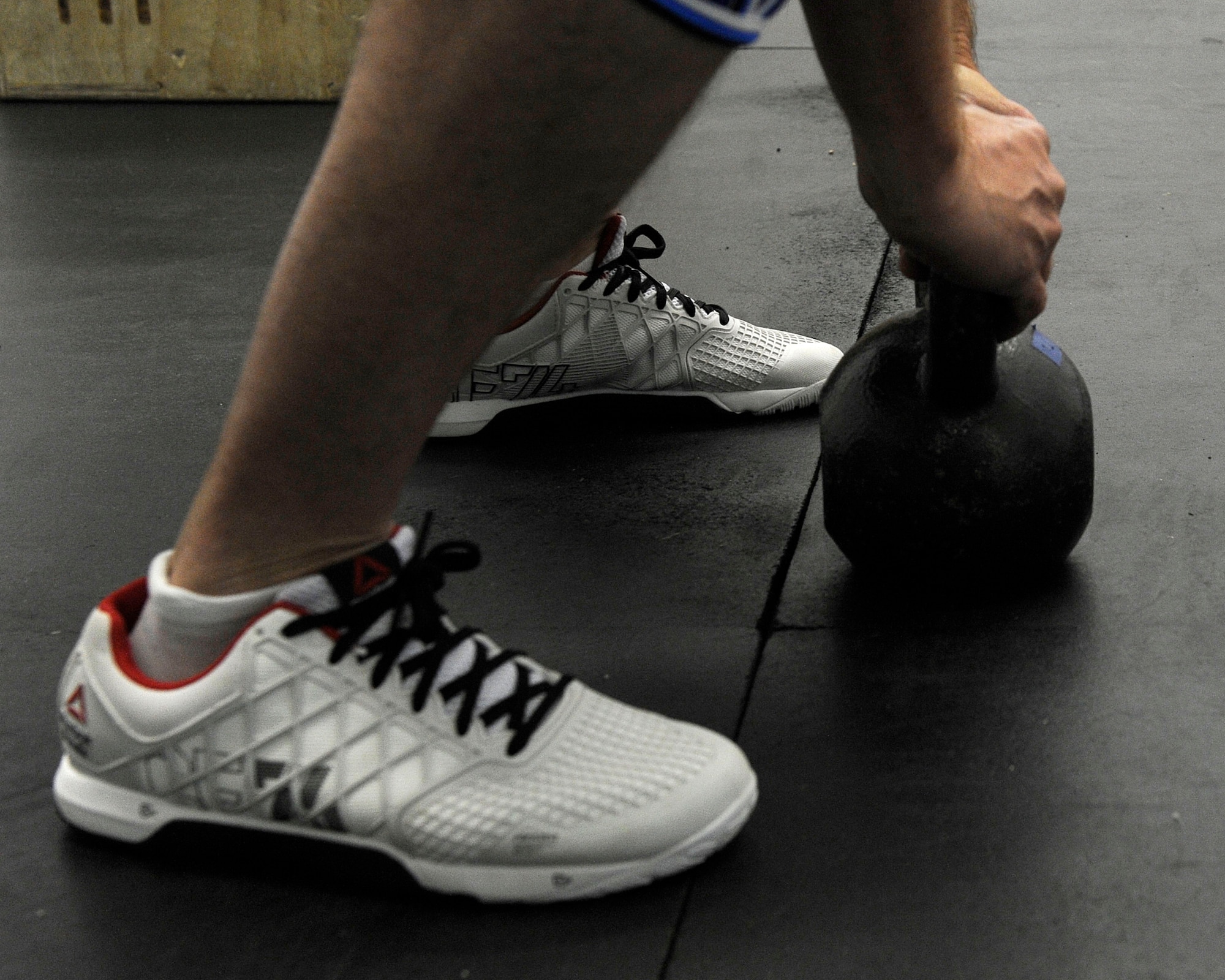 U.S. AIR FORCE ACADEMY, Colo. – Master Sgt. Benjamin “Paul” Horton, 21st Civil Engineer Squadron explosive ordnance disposal program manager, does squats with a kettlebell to get in a good workout in at the Academy Fitness Center Sept. 3. Horton is training for the first-ever Invictus Games, which will take place in London Sept. 10-14. The Games will help combat warriors prove they still have a purpose and cannot be defeated just from being wounded in combat. (U.S. Air Force photo/Airman 1st Class Rose Gudex)