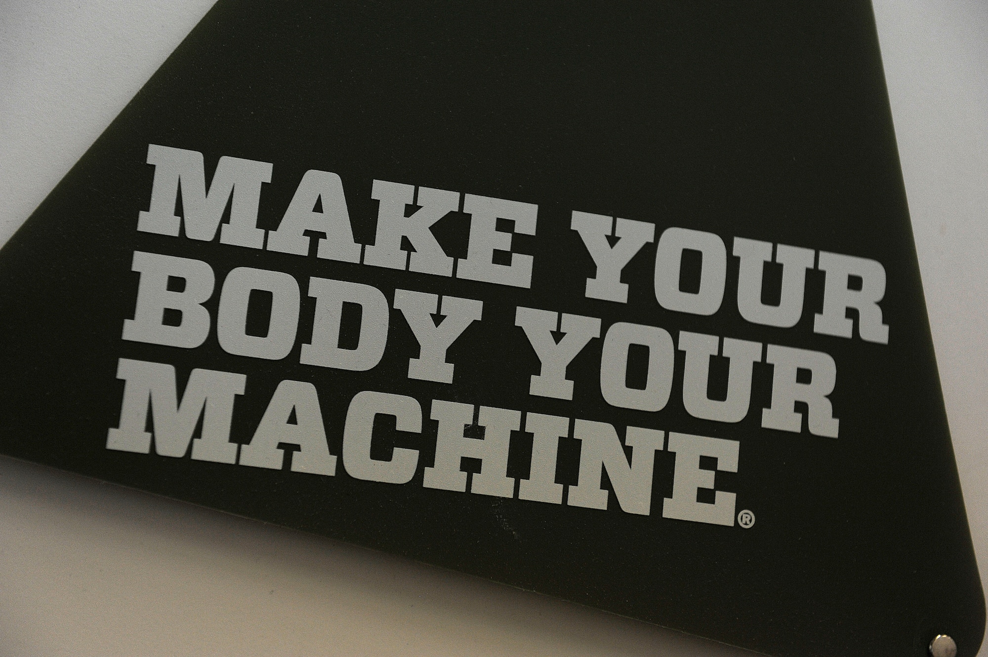 U.S. AIR FORCE ACADEMY, Colo. – A motivational sign hangs on the wall of the U.S. Air Force Academy Fitness Center Sept. 3. Master Sgt. Benjamin “Paul” Horton, 21st Civil Engineer Squadron explosive ordnance disposal program manager, was invited to participate in the inaugural Invictus Games in London and works out at the fitness center regularly to prepare. (U.S. Air Force photo/Airman 1st Class Rose Gudex)