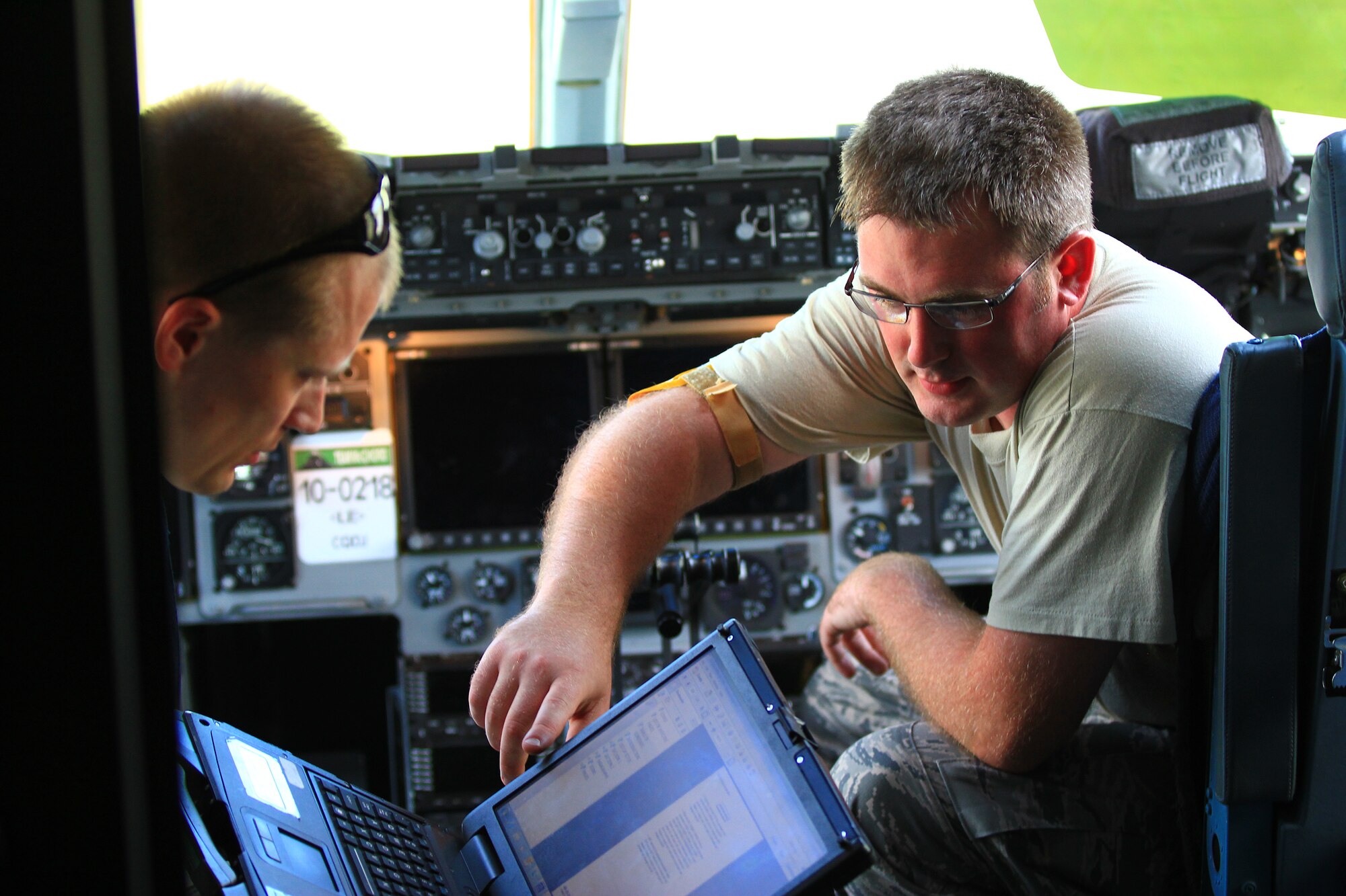 KADENA AIR BASE, Japan – Staff Sgt. Timothy Emberton, 445th Aircraft Maintenance Squadron avionics guidance and control technician, conducts maintenance check training on a C-17 Globemaster III with Airmen assigned to the 733rd Air Mobility Squadron, Kadena Air Base, Okinawa, Japan, July 27, 2014. (U.S. Air Force photo by Tech. Sgt. Patrick O’Reilly)