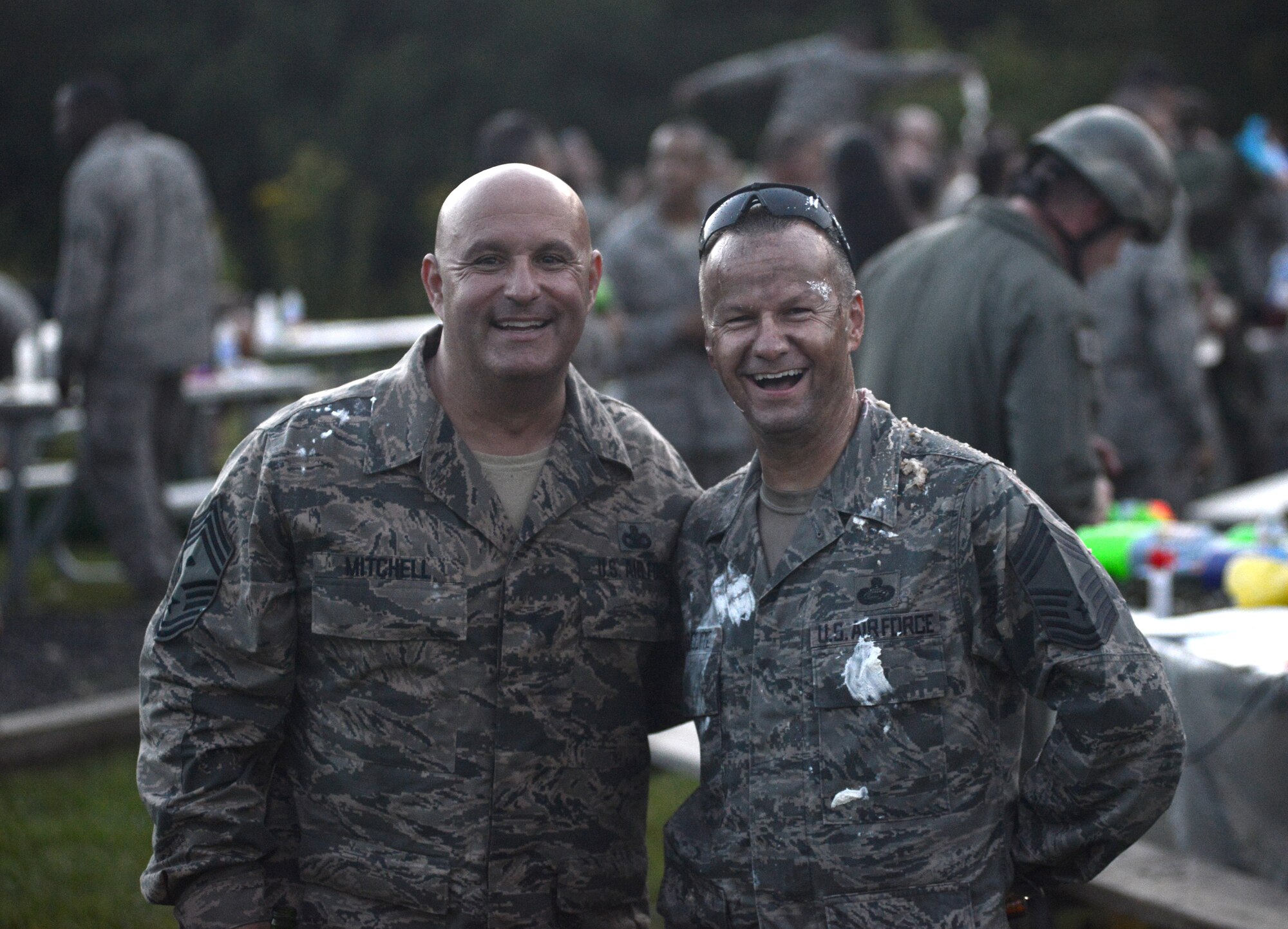 Chief Master Sgt. Daniel Mitchell and Chief Master Sgt. Danny Doucette are all smiles after a combat dining-in at the Air National Guard 2014 Enlisted Leadership Symposium, Aug. 28, 2014, at Camp Dawson, W.V. The combat dining-in was a resiliency building event to cap off three days of professional development and leadership training for the more than 400 Airmen who attended. (U.S. Air National Guard photo by Senior Airman John E. Hillier)
