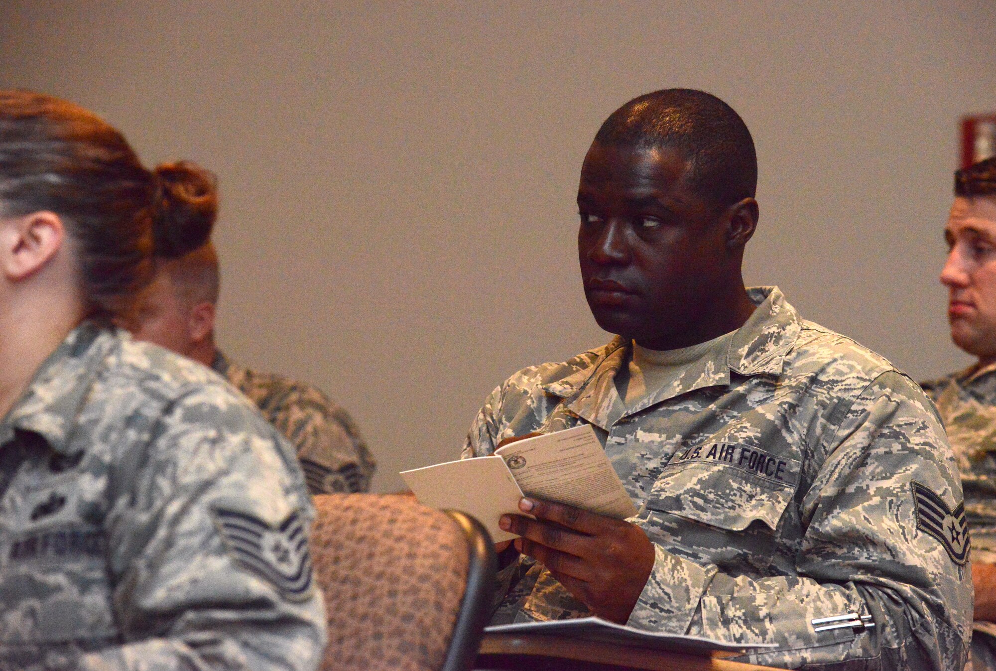 Staff Sgt. Kylief Tucker, a sheet metal fabrication specialist with the 109th Airlift Wing, takes notes during a presentation on the enlisted force structure by Command Chief Master Sergeant of the Air National Guard James W. Hotaling at the Enlisted Leadership Symposium, held Aug. 26-28, 2014, at Camp Dawson, W.V. Airmen from each of the 50 states, territories and the District of Columbia that make up the ANG came together for three days of professional development and leadership training. (U.S. Air National Guard photo by Senior Airman John E. Hillier)