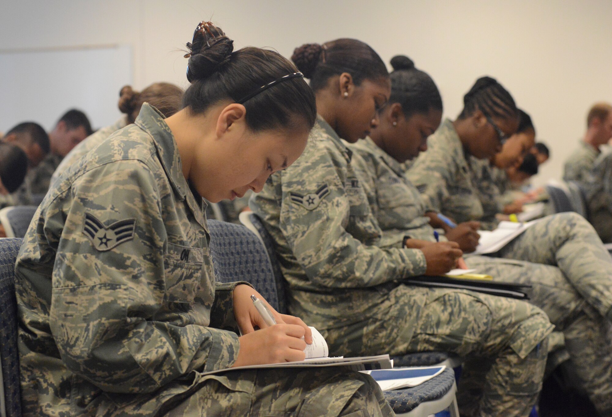 Senior Airman Kellie Oh, a command post specialist with the 154th Wing, Hawaii Air National Guard, takes notes during a discussion on the enlisted force structure at the Enlisted Leadership Symposium held at Camp Dawson, W.V., Aug. 26-28, 2014. Airmen from each of the 50 states, territories and the District of Columbia that make up the ANG came together for three days of professional development and leadership training. (U.S. Air National Guard photo by Senior Airman John E. Hillier)