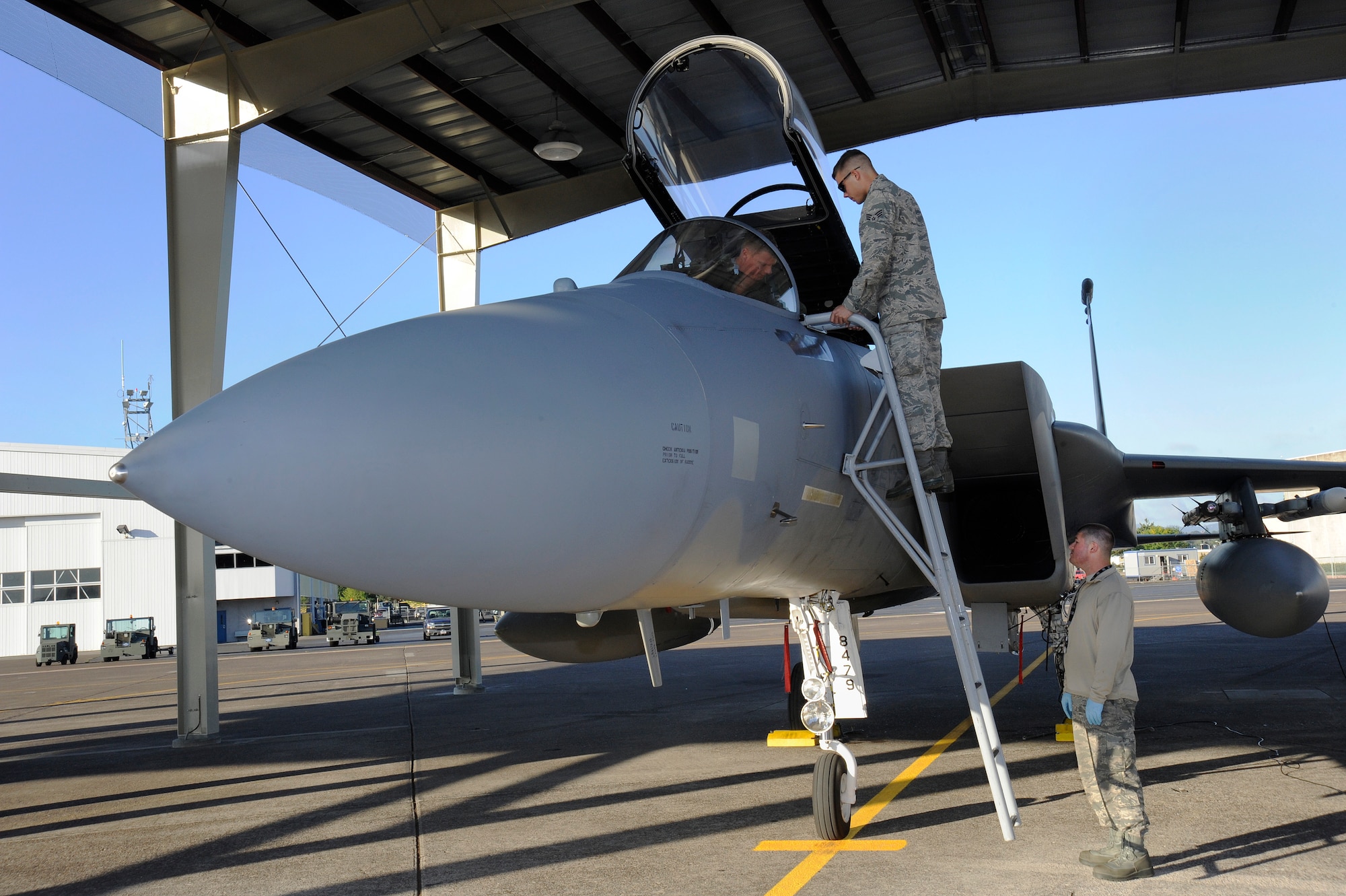 Lt. Col. Todd Hofford, pilot with the 123rd Fighter Squadron begins to prepare for a morning flight as Senior Airman Adam Burger (ladder) and Master Sgt. Dustin Brice, assigned to the 142nd Fighter Wing Aircraft Maintenance Group, begin pre-flight maintenance operations, Sept. 4, Portland Air National Guard Base, Ore.  (U.S. Air National Guard photo by Tech. Sgt. John Hughel, 142nd Fighter Wing Public Affairs/Released)