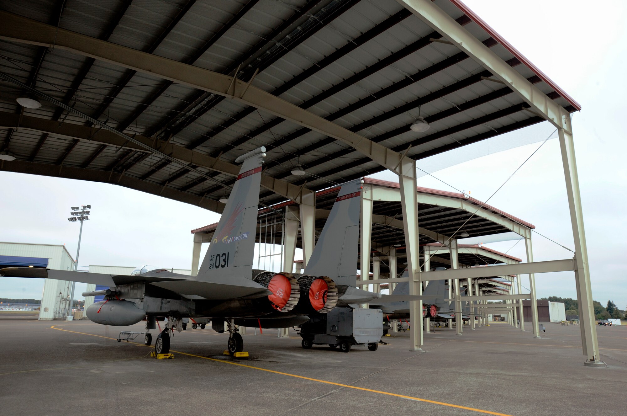 An F-15 Eagle sits in one of the new aircraft shelters at the Portland Air National Guard Base, Ore., flightline, Aug. 28, 2014, after nine new aircraft shelters have been completed to help protect the 142nd Fighter Wing F-15 Eagles from environmental elements. (U.S. Air National Guard photo by Tech. Sgt. John Hughel, 142nd Fighter Wing Public Affairs/Released)