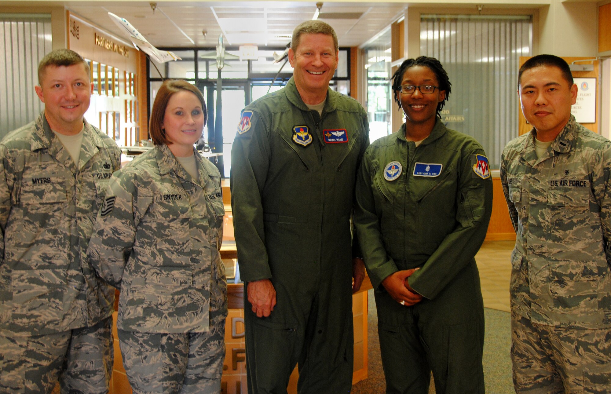 VANCE AIR FORCE BASE, Okla. -- Gen. Robin Rand, the Air Education & Training Command commander (center), presented commander’s coins to (from left) Tech. Sgt. Richard Myers, Tech. Sgt. Amy Snyder, Staff Sgt. Kira Cox and 1st Lt. Tae Lee during his Sept. 4 visit. Rand was also the guest speaker for the graduation of Joint Specialized Undergraduate Pilot Training Class 14-14. (U.S. Air Force photo/ 2nd Lt. Tho Dang)