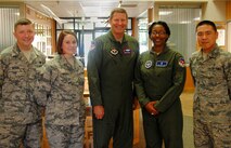 VANCE AIR FORCE BASE, Okla. -- Gen. Robin Rand, the Air Education & Training Command commander (center), presented commander’s coins to (from left) Tech. Sgt. Richard Myers, Tech. Sgt. Amy Snyder, Staff Sgt. Kira Cox and 1st Lt. Tae Lee during his Sept. 4 visit. Rand was also the guest speaker for the graduation of Joint Specialized Undergraduate Pilot Training Class 14-14. (U.S. Air Force photo/ 2nd Lt. Tho Dang)