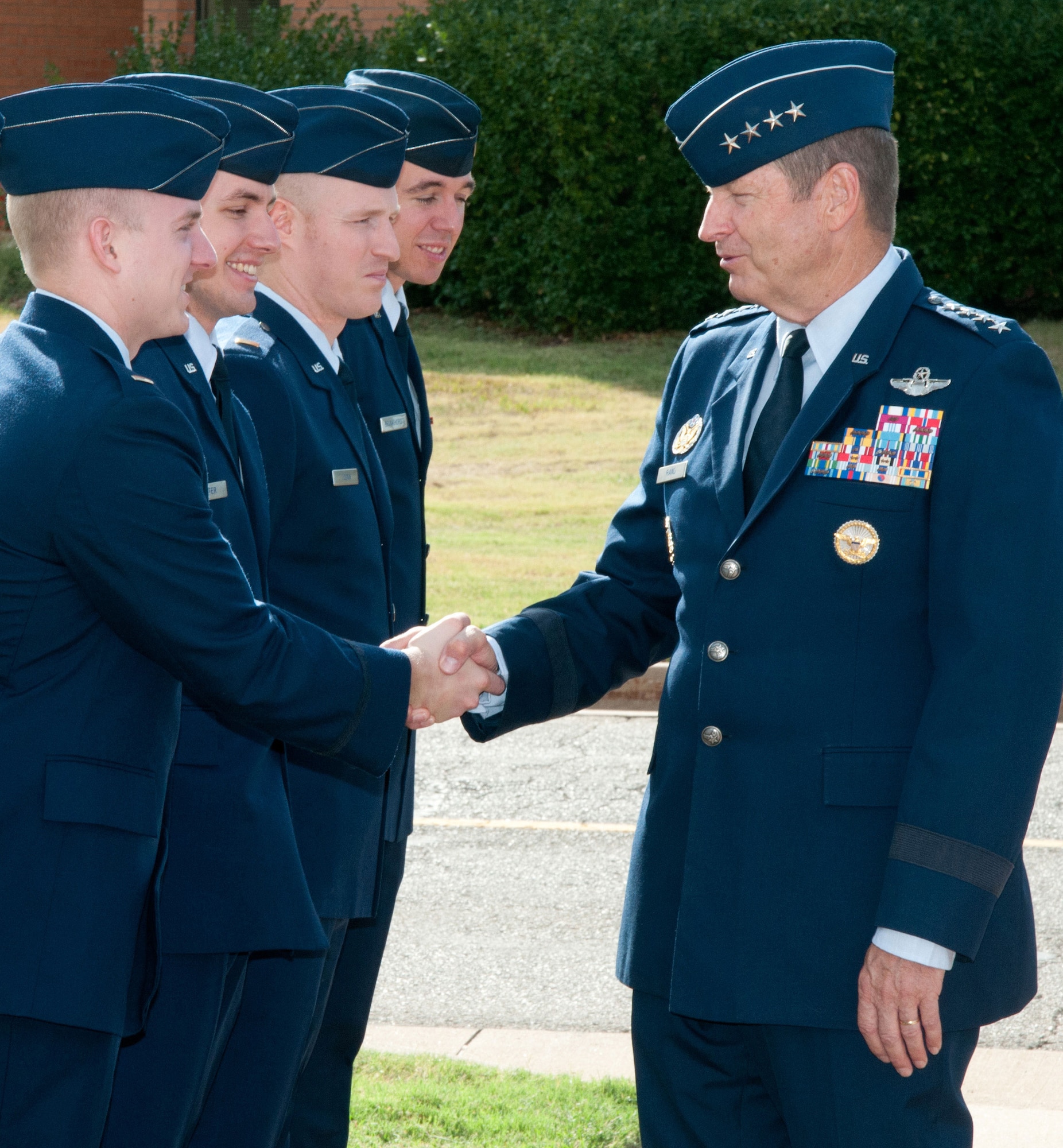 VANCE AIR FORCE BASE, Okla. -- Gen. Robin Rand, the Air Education & Training Command commander (right), congratulates the graduates of Joint Specialized Undergraduate Pilot Training Class 14-14 before graduation Sept. 5 outside the Base Auditorium. (U.S. Air Force photo/ Terry Wasson)