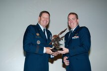 VANCE AIR FORCE BASE, Okla. -- Gen. Robin Rand, the Air Education & Training Command commander (left), presents the AETC Commander’s Trophy to Capt. David Jeffery, a member of Joint Specialized Undergraduate Pilot Training Class 14-14, during graduation Sept. 5 at the Base Auditorium. (U.S. Air Force photo/ Terry Wasson)