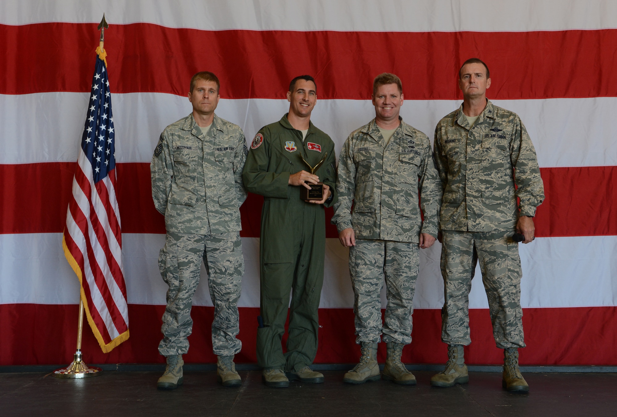 Members of the 115th Fighter Wing safety team pose on stage after being presented the 2013 William W. Spruance Award during Wingman Day in Madison, Wis., on Sept. 7, 2014. The award was originally presented during the 136th General Conference and Exhibition, however this was the first chance the entire unit was able to see it. (Air National Guard photo by Senior Airman Andrea F. Liechti)
