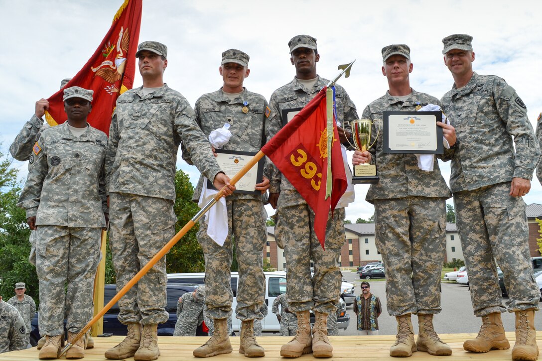 Members of the 393rd Harbor Master Operations Detachment, 11th Transportation Battalion, 7th Trans. Bde. (Ex.), receive accolades after placing first at the Resolute Challenge at Fort Eustis, Va., Sept. 5, 2014. The team demonstrated a resolute attitude while negotiating physically and mentally demanding events during challenge. (U.S. Army photo by Spc. Marian Alleva/Released)