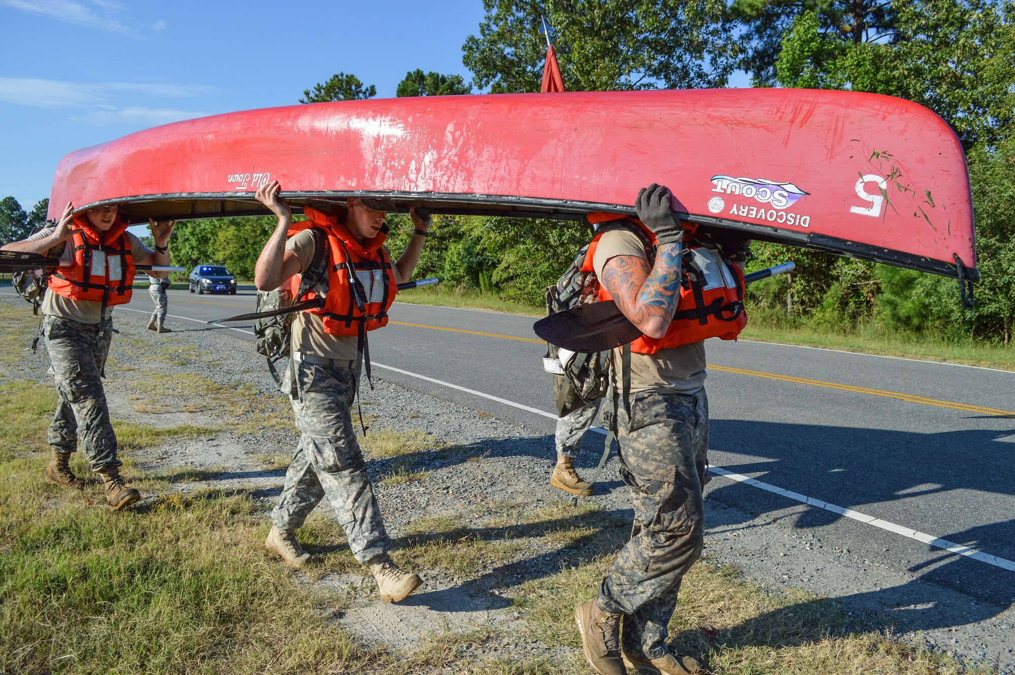 U.S. Army Soldiers from the 1098th Transportation Company, 11th Transportation Battalion, 7th Trans. Bde. (Ex.), carry a canoe and paddles from Lake Eustis to Third Port during the Resolute Challenge at Fort Eustis, Va., Sept. 5, 2014. The 7th Transportation Brigade (Expeditionary) held its quarterly Resolute Challenge to foster friendly competition among its subordinate units. (U.S. Army photo by Spc. Marian Alleva/Released)