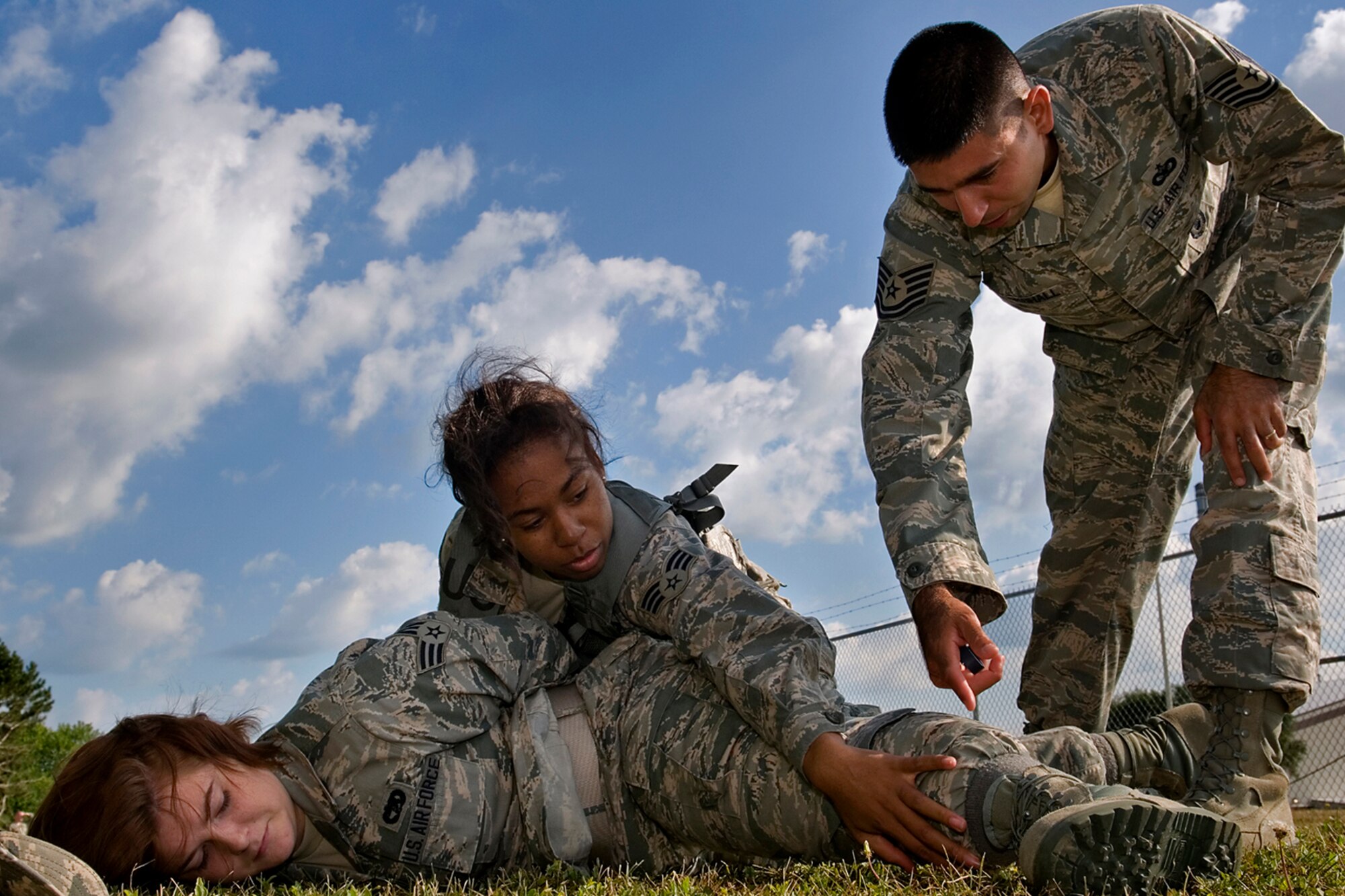 Tech. Sgt. James Marshall, 434th Security Forces Squadron fire team leader and combat training instructor, points out search areas to Senior Airman Caresia Barton, 434th Logistics Readiness Squadron material management apprentice, as she searches Senior Airman Kelsey McFadden, 49th Aerial Port Flight aerial port specialist, for contraband during a security forces augmentee field-training exercise at Grissom Air Reserve Base, Aug. 11, 2014. Twenty-five Grissom Airmen participated in the week-long course to hone their combat training skills and help aid the 434th Security Forces Squadron during various missions. (U.S. Air Force photo/Staff Sgt. Ben Mota)
