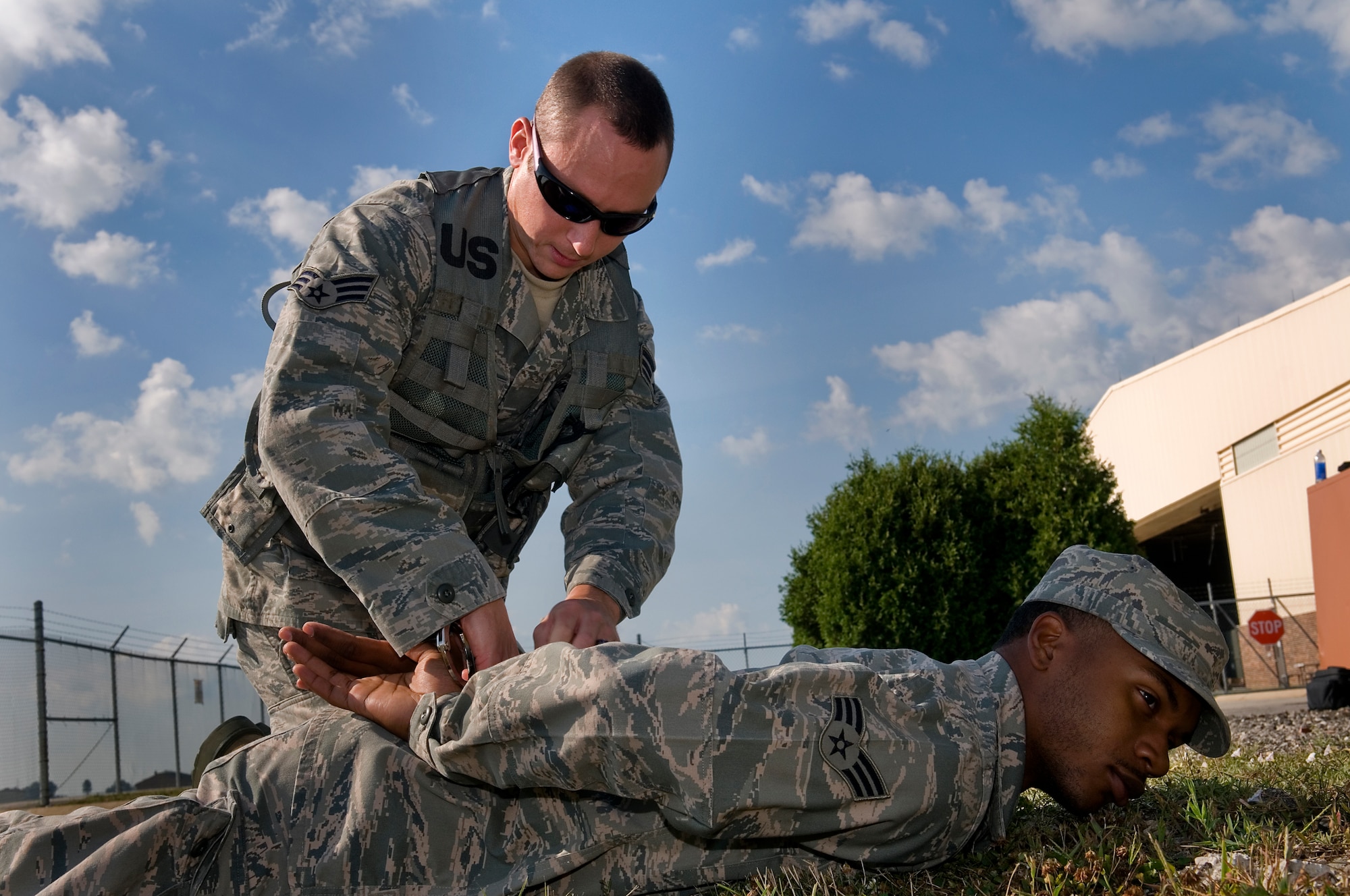 Senior Airman Rodriguez Bradley, 434th Civil Engineer Squadron firefighter, handcuffs Senior Airman Kevin Bradley, 434th Civil Engineer Squadron operations management specialist, during a security forces augmentee field-training exercise at Grissom Air Reserve Base, Aug. 11, 2014. Twenty-five Grissom Airmen participated in the week-long course to hone their combat training skills and help aid the 434th Security Forces Squadron during various missions. (U.S. Air Force photo/Staff Sgt. Ben Mota)
