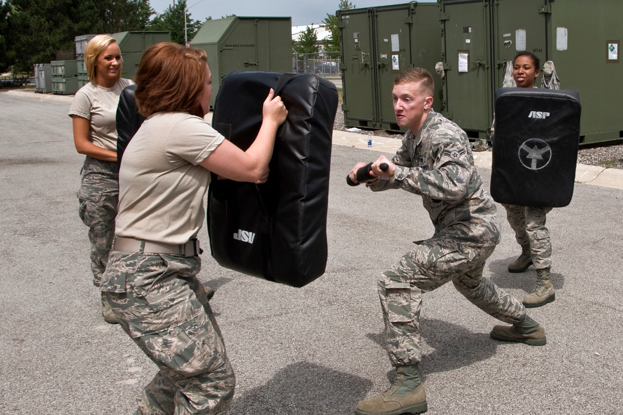 Senior Airman Dillon Easley-Frederickson, 434th Civil Engineer Squadron firefighter, defends himself as Senior Airman Kelsey McFadden, 49th Aerial Port Flight aerial port specialist, simulates an aggressive attack during a security forces augmentee field-training exercise at Grissom Air Reserve Base, Aug. 11, 2014. Twenty-five Grissom Airmen participated in the week-long course to hone their combat training skills and help aid the 434th Security Forces Squadron during various missions. (U.S. Air Force photo/Staff Sgt. Ben Mota)