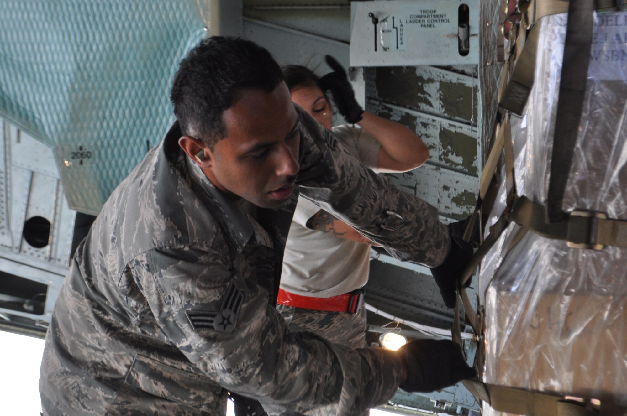 TRAVIS AIR FORCE BASE, Calif. -- Senior Amn. Alfred Ledoux and Tech. Sgt. Kelly Sobieski check their alignment as they roll a pallet onto a C-5 during a full, 36-pallet load on the Travis Air Force Base flight line. Ledoux is assigned to the Reserve’s 82nd APS at Travis AFB, and Sobieski is a reservist with the 26th APS from Joint Base San Antonio. (U.S. Air Force photo/Ellen Hatfield)