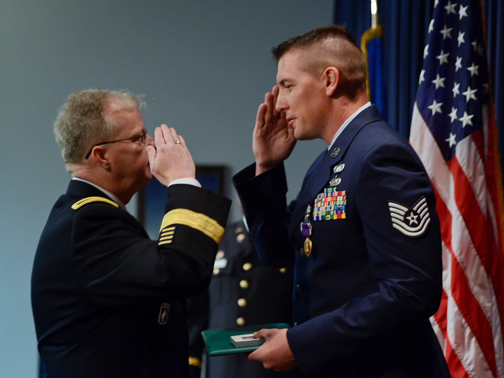 Oklahoma Air National Guard Tech. Sgt. Kody Jorgensen, assigned to the 138th Logistics Readiness Squadron, receives a Purple Heart from Brig. Gen. Craig M. McGalliard, Assistant Adjutant General - Army, Georgia National Guard, Commander 78th Troop Command, Sept. 6, 2014, at the Tulsa Air National Guard base, Tulsa Okla. Jorgensen was wounded August 27, 2012, while serving in Afghanistan with the Georgia National Guard's 265th Regional Support Group, Agri-business Development Team II.  (U.S. National Guard photo by Master Sgt.  Mark A. Moore/Released)