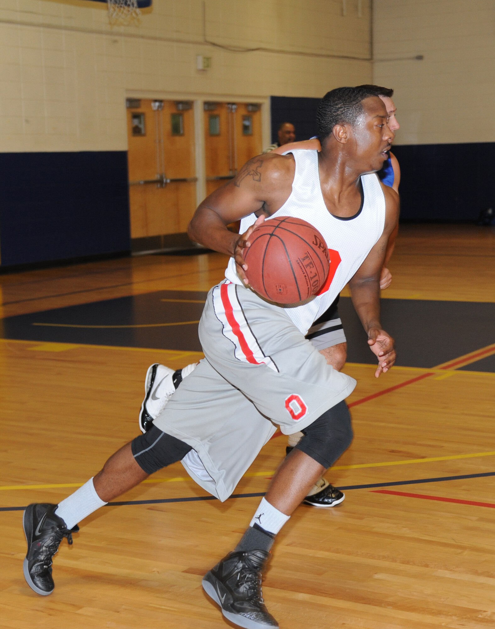 Torrence Polland, Gulfport Army Recruiting Station team, drives the ball down the court during an intramural basketball game against the 81st Aerospace Medicine Squadron team Sept. 9, 2014, at the Blake Fitness Center, Keesler Air Force Base, Miss.  Following double overtime, the Gulfport Army Recruiting Station team defeated the 81st AMDS team, 74-68. (U.S. Air Force photo by Kemberly Groue)