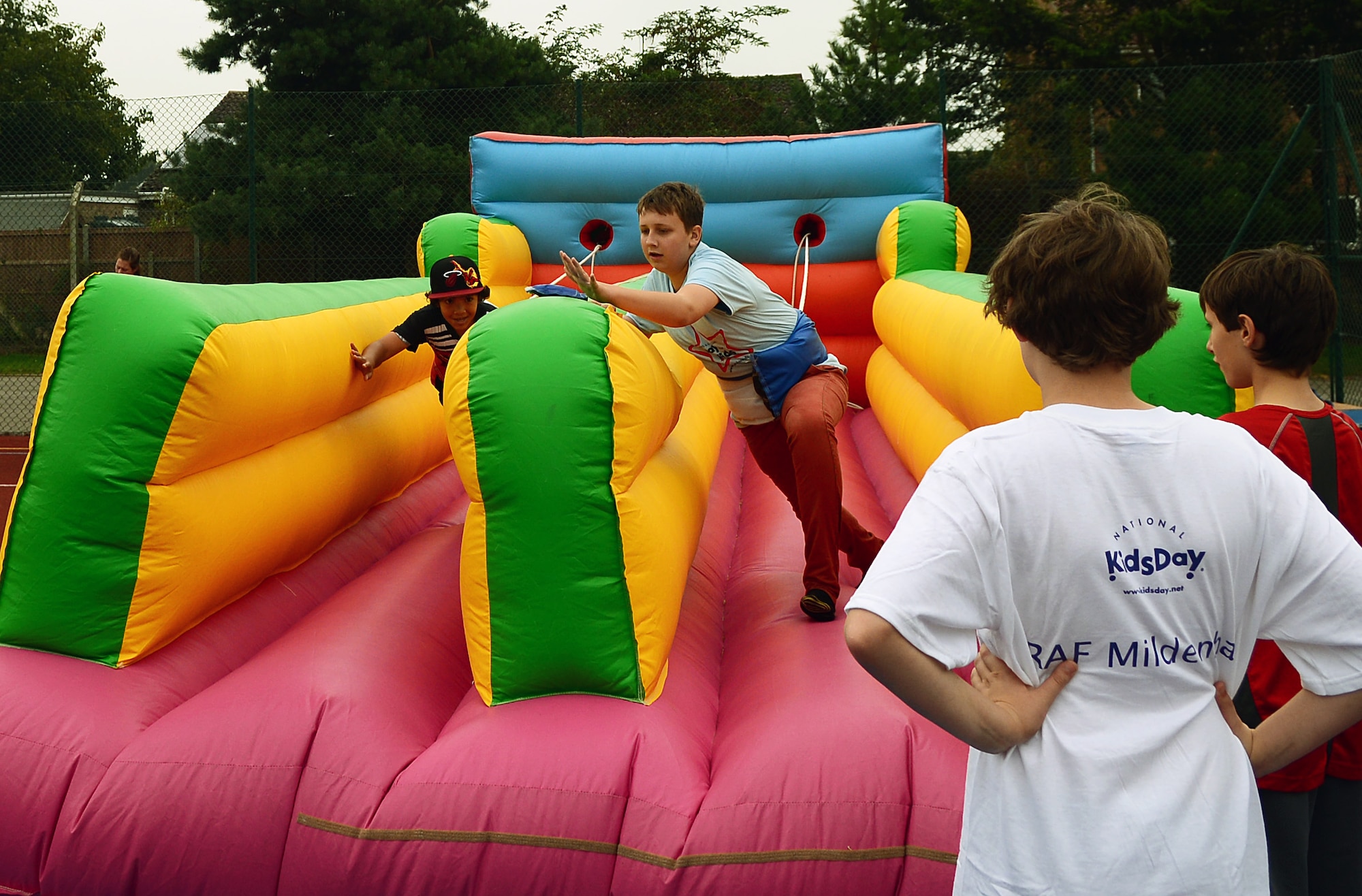 Team Mildenhall and Liberty Wing children compete in a “bungee run” during the 100th Force Support Squadron Youth Center Day for Kids Sept. 6, 2014, at RAF Mildenhall, England. Day for Kids is an annual event filled with games, food and fun. (U.S. Air Force photo/Airman 1st Class Jonathan Light/Released)