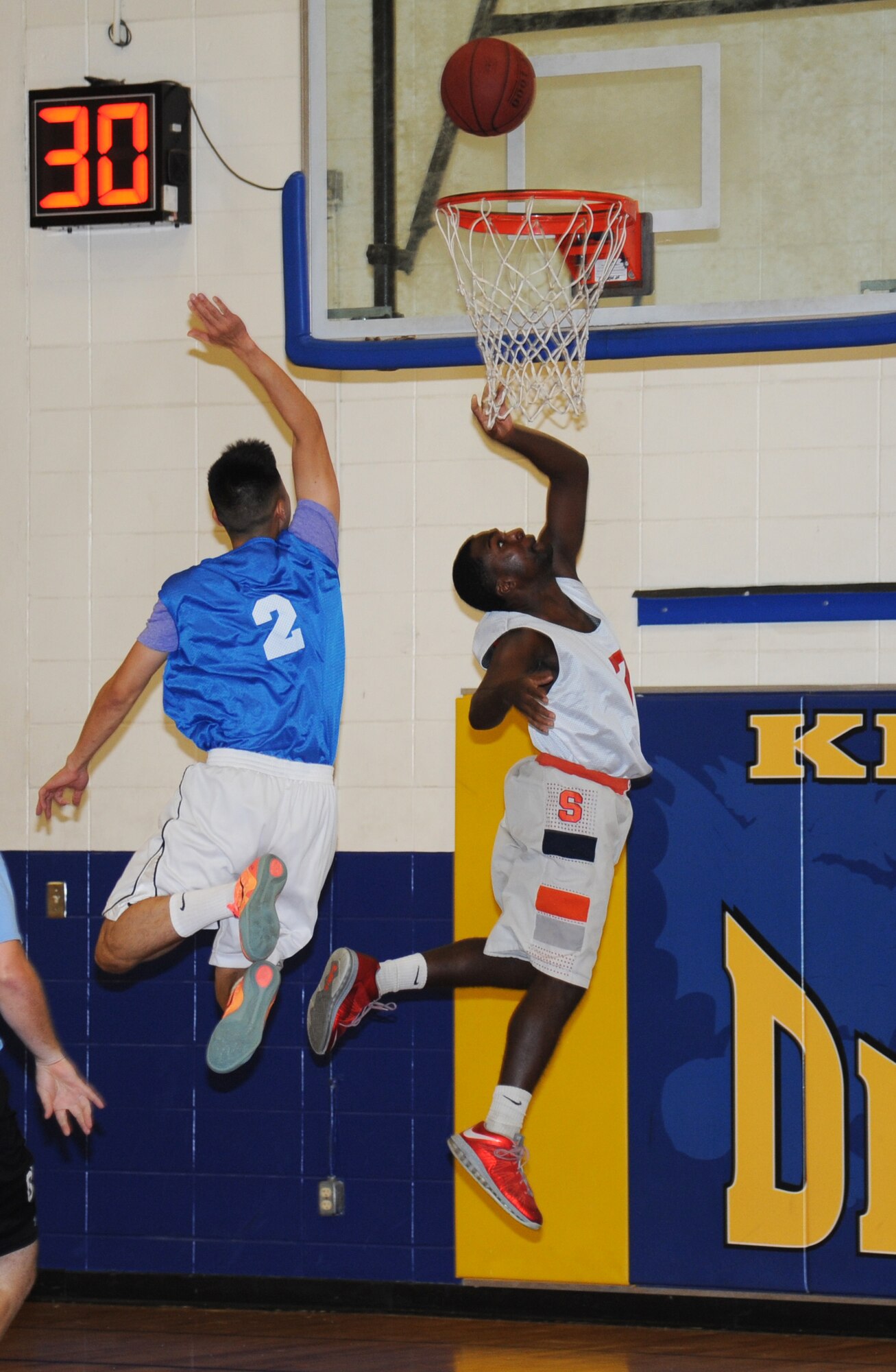 Emmanuel Freduah, 81st Aerospace Medicine Squadron team, attempts to block a lay-up shot by Julius Turner, Gulfport Army Recruiting Station team, during an intramural basketball game Sept. 9, 2014, at the Blake Fitness Center, Keesler Air Force Base, Miss.  Following double overtime, the Gulfport Army Recruiting Station team defeated the 81st AMDS team, 74-68. (U.S. Air Force photo by Kemberly Groue)