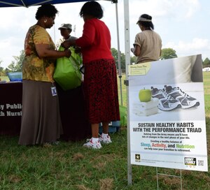 Members of Army Public Health Nursing provide Joint Base Langley-Eustis, Va., community members with information about the Performance Triad plan during a Home Run for Health event at Fort Eustis, Va., Sept. 3, 2014. The event wrapped up a three-month campaign to encourage participants to get more sleep, increase daily activity and make healthier nutritional choices. (U.S. Air Force photo by Staff Sgt. Teresa J. Cleveland/Released)