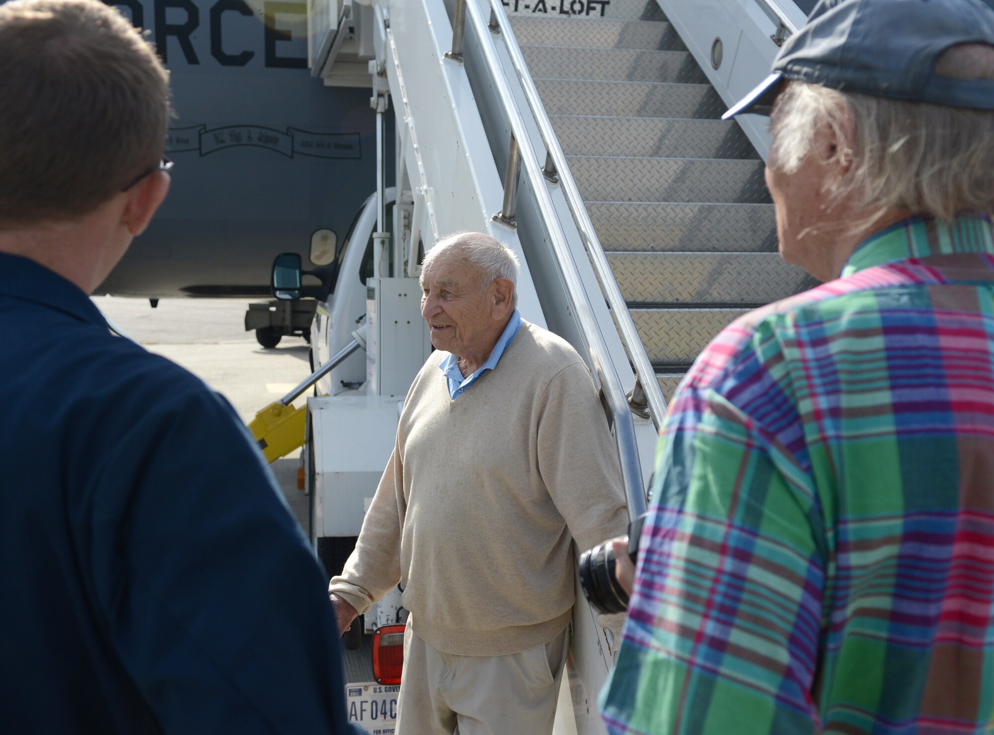 World War II veteran Herb Wilkov, 90, center, speaks with Team Mildenhall Airmen and members of his reunion group during a tour of a KC-135 Stratotanker Sept. 9, 2014, on RAF Mildenhall, England. Wilkov served in the Army Air Corps as a navigator during World War II. (U.S. Air Force photo/Airman 1st Class Dillon Johnston/Released)