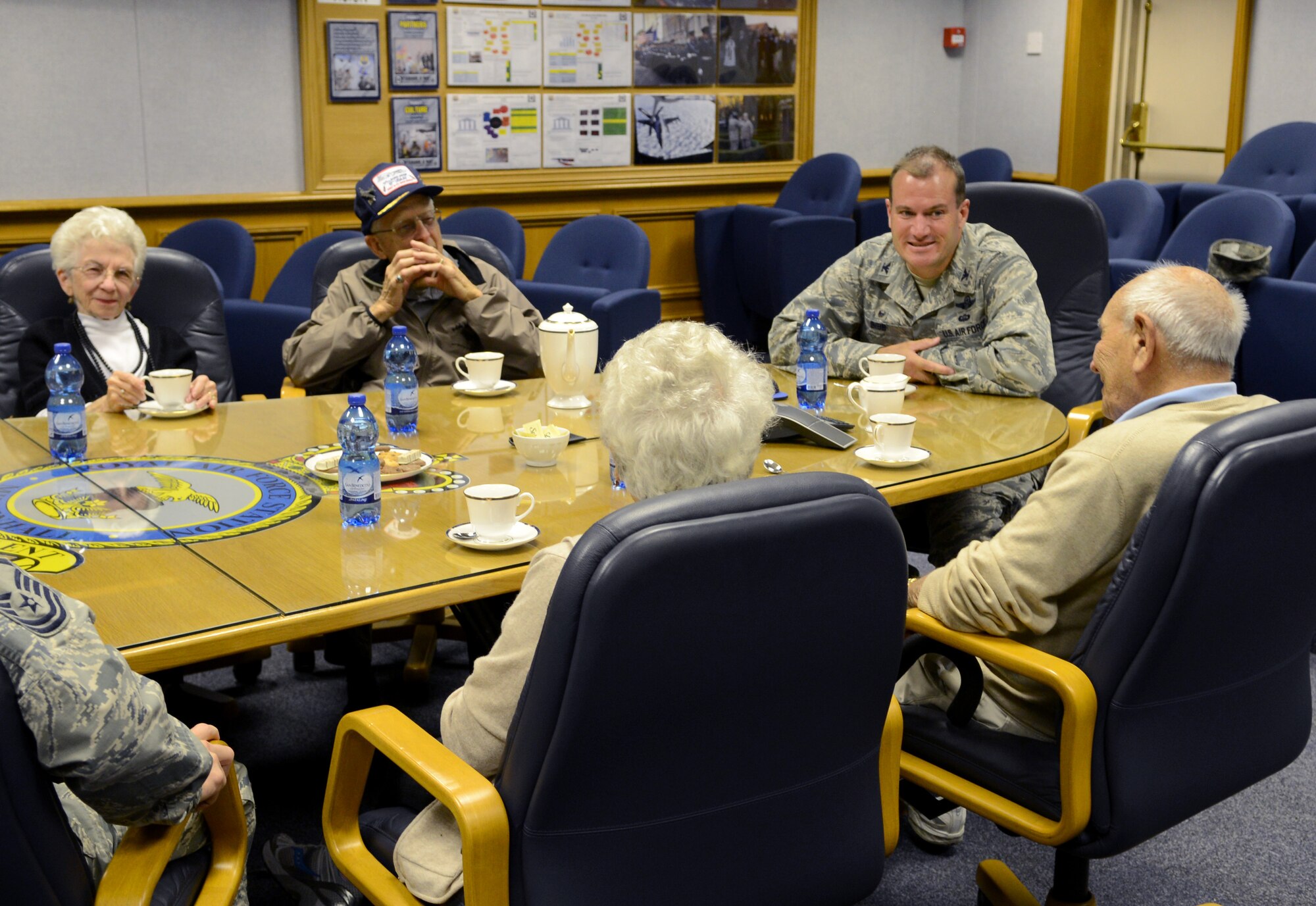 U.S. Air Force Col. Kenneth T. Bibb Jr., second from right, 100th Air Refueling Wing commander, speaks with World War II veterans Bob Fay, 89, second from left, and Herb Wilkov, 90, right, and their spouses Sept. 9, 2014, on RAF Mildenhall, England. Fay and Wilkov visited RAF Mildenhall as part of a reunion for World War II veterans. (U.S. Air Force photo/Airman 1st Class Dillon Johnston/Released)