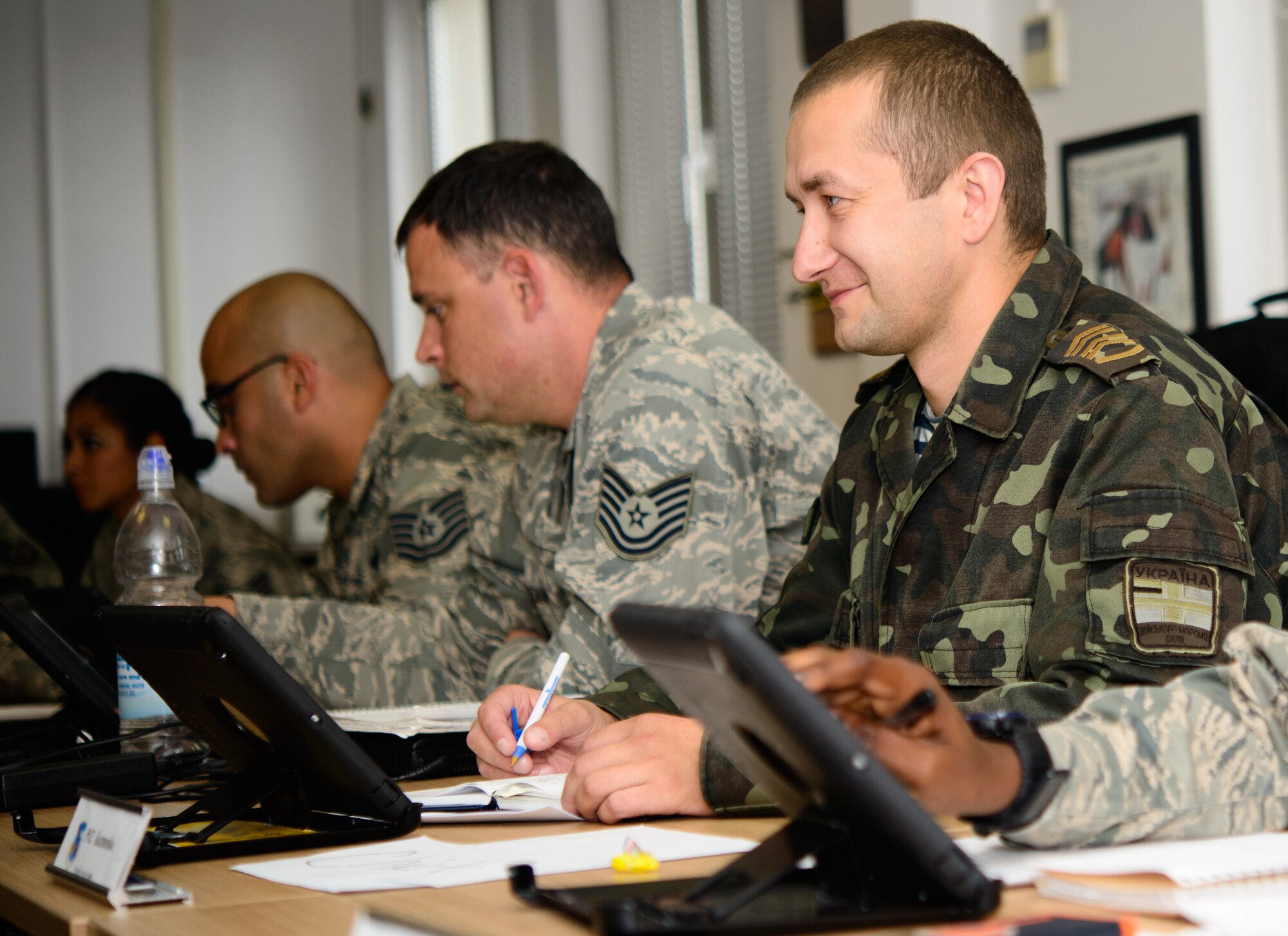 Ukrainian (Chief Master Sgt.equivalent) Roman Kuzmenko, Ukrainian Armed Forces General Staff, middle, listens to a discussion during a class at the Kisling NCO Academy Aug. 29, 2014, at Ramstein Air Base, Germany. Kuzmenko is part of a Department of Defense initiative designed to improve the NCOs of partner countries. (U.S. Air Force photo/Senior Airman Armando A. Schwier-Morales) 