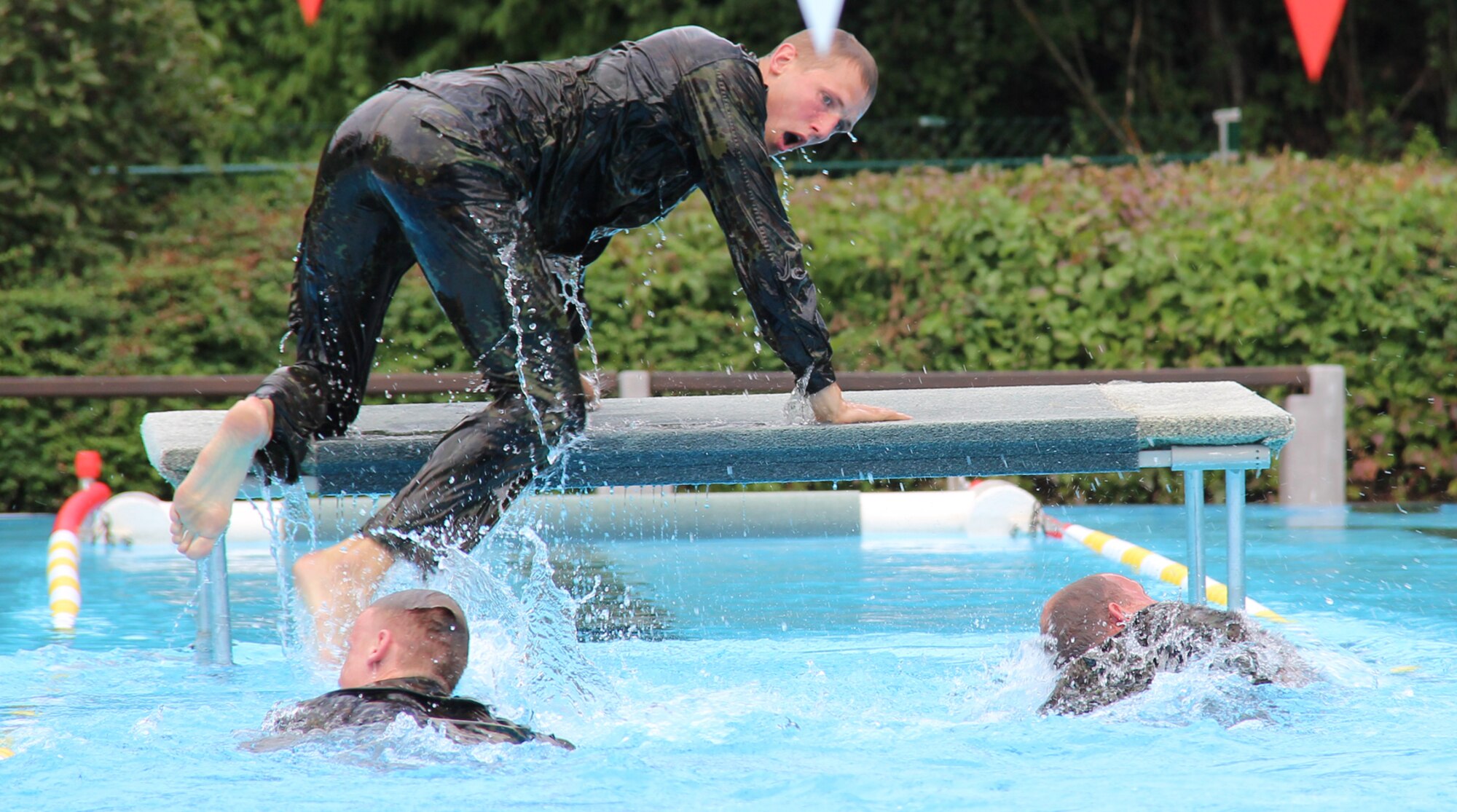 A swimmer mounts a platform Aug. 3, 2014, during the 50-meter water obstacle
course at the 2014 CIOR Military Competition in Hammelburg, Germany.
Reservists in teams representing more than 20 nations competed in the
military pentathlon July 31-Aug. 9.  (Courtesy photo by Sören Peters, German Armed Forces Reservists Association)
