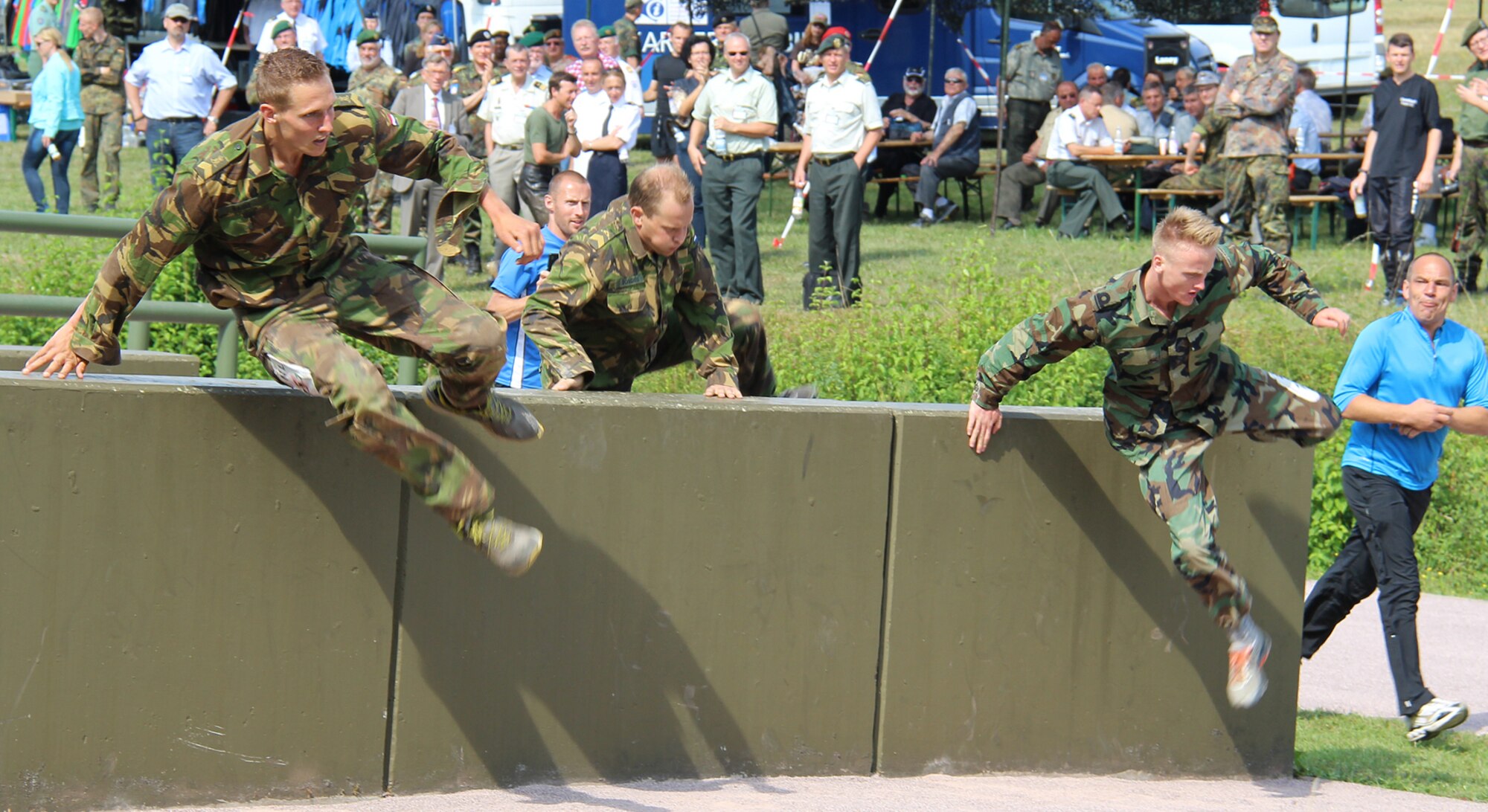 Military competitors negotiate a barrier Aug. 6, 2014, during the 2014 CIOR
Military Competition in Hammelburg, Germany.  The 500-meter land obstacle
course consisted of 20 obstacles designed to test strength, stamina,
coordination and flexibility.  (Courtesy photo by Sören Peters, German Armed Forces Reservists Association)
