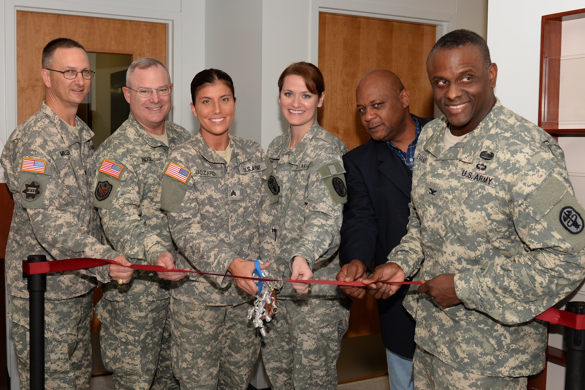 U.S. Army Col. Robert Miller, Northern Regional Dental Command commander, Fort Belvoir, Va., Maj. Gen. Ross Ridge, Initial Military Training Center of Excellence, U.S. Army Training and Doctrine Command deputy commanding general, and Joint Base Langley-Eustis Senior Army Element commander, Sgt. Stephanie Bozard, Tignor Dental Clinic noncommissioned officer-in-charge, Capt. Elsie Hinz, Tignor Dental Clinic officer-in-charge, Michael Vail, McDonald Army Health Center facility management branch engineer and project manager, and Col. Michael Evans, Dental Activity commander, perform a ribbon cutting ceremony of the newly-renovated Tignor Dental Clinic at Fort Eustis, Va., Sept. 9, 2014. Construction on the 1960s-era clinic began in January 2013 to renovate the facility with state-of-the-art equipment and 28 dental treatment operatories. (U.S. Air Force photo by Staff Sgt. Teresa J. Cleveland/Released)